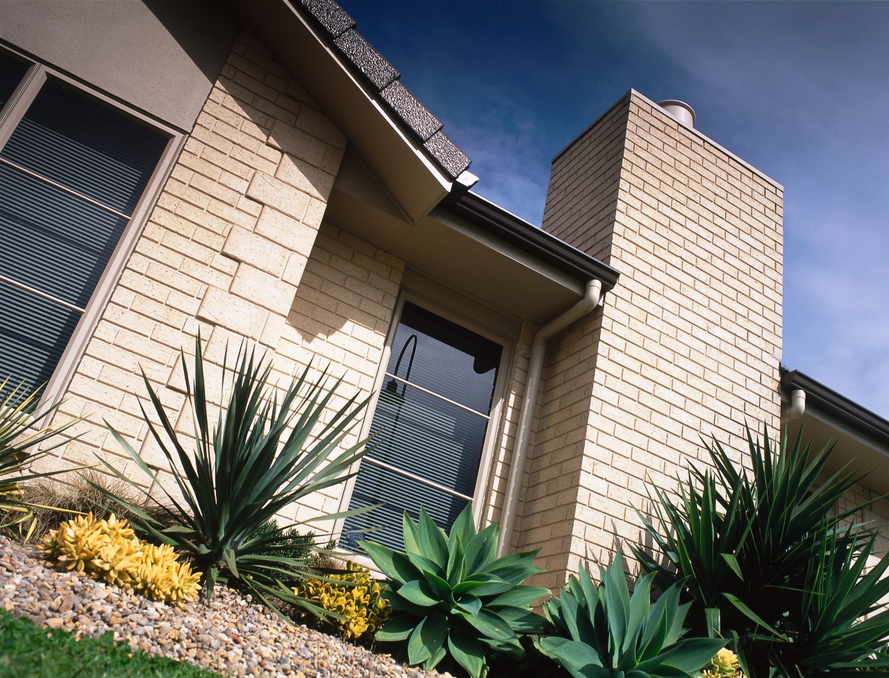View of front of light coloured brick home. architecture, building, facade, home, house, property, real estate, residential area, siding, window