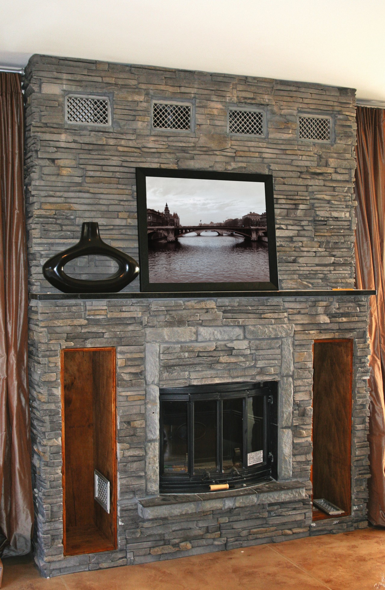 View of fireplace featuring stone cladding. facade, fireplace, hearth, wall, gray, brown