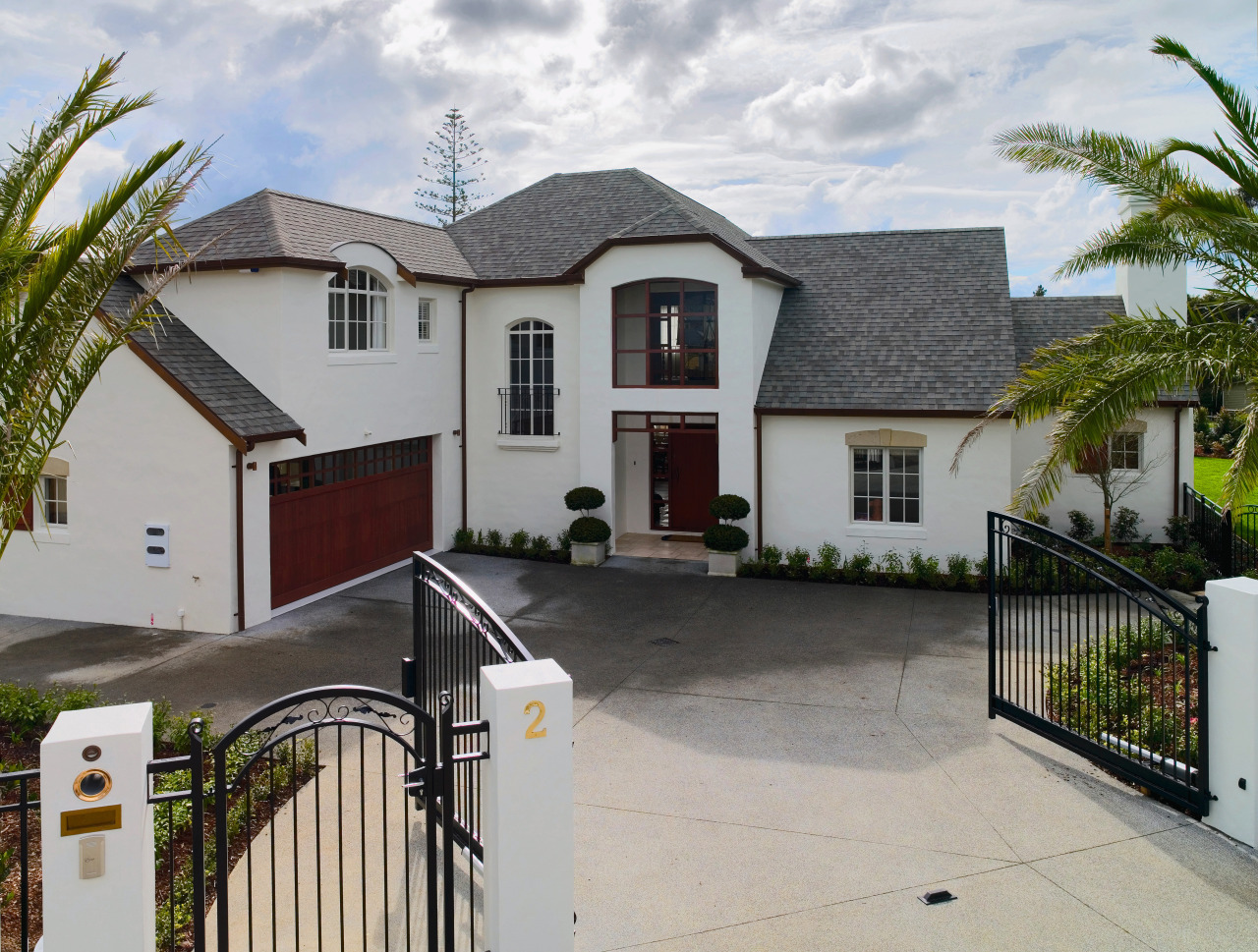 Large cream coloured masonry home with steep shingle building, cottage, estate, facade, home, house, neighbourhood, property, real estate, residential area, roof, window, gray