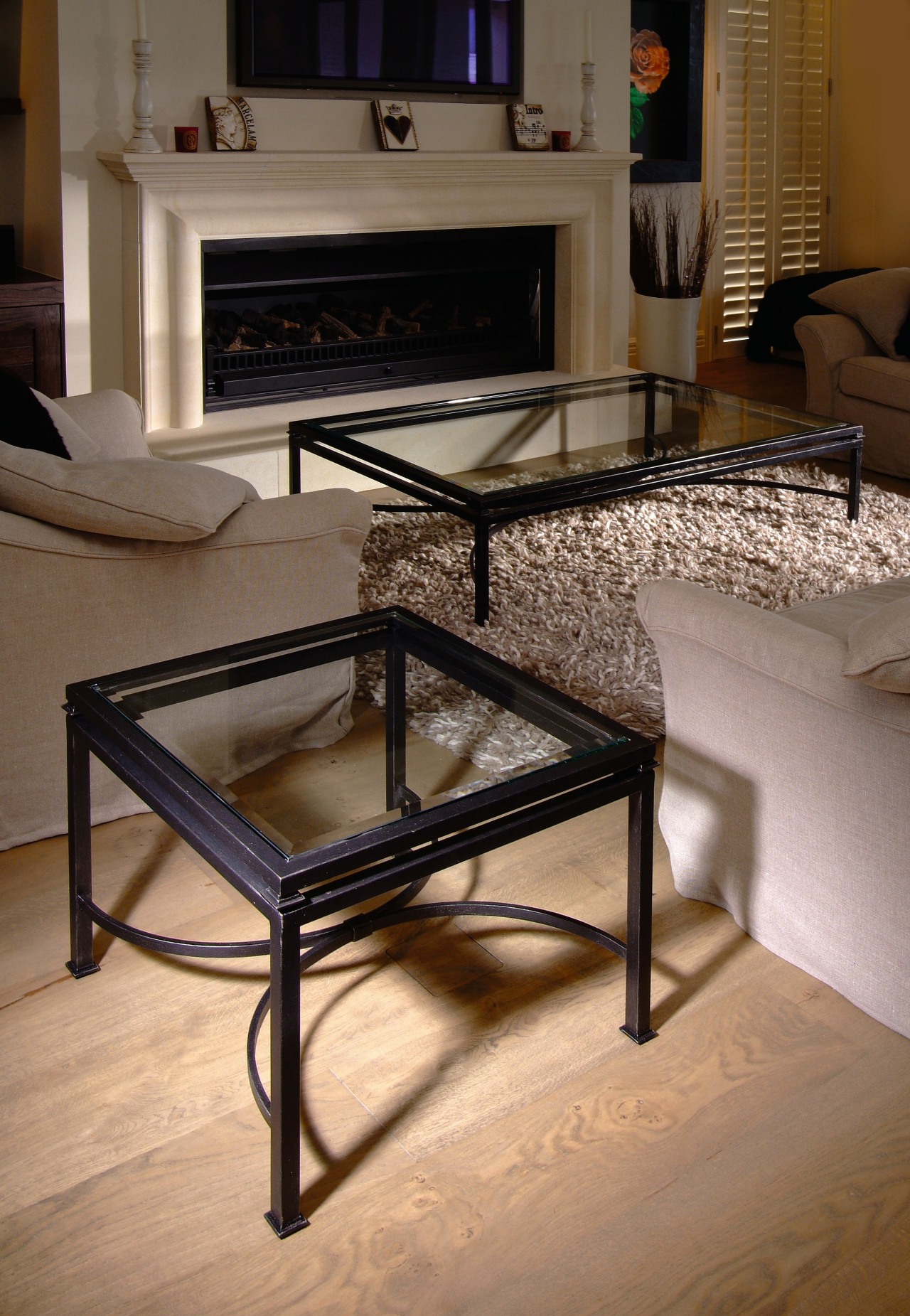 Wrought iron coffee and lamp tables in lounge chair, coffee table, floor, flooring, furniture, interior design, table, wood, brown