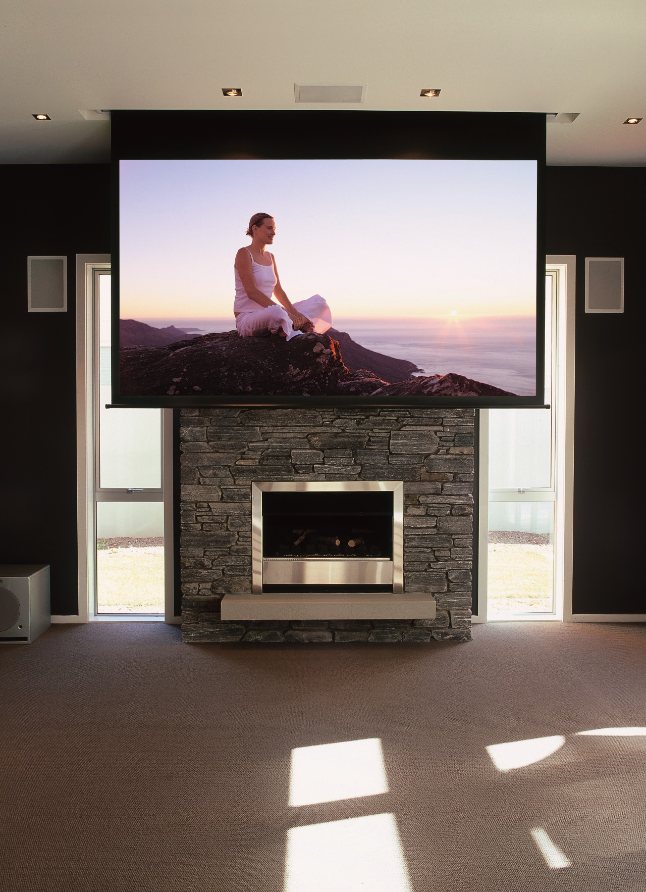 Lounge room showing large viewing screen over fireplace. fireplace, floor, flooring, furniture, hearth, home, home appliance, interior design, living room, room, black, white