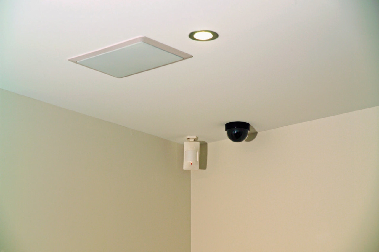 Ceiling with security camera detector and speaker. ceiling, daylighting, light fixture, lighting, plaster, product design, wall, gray