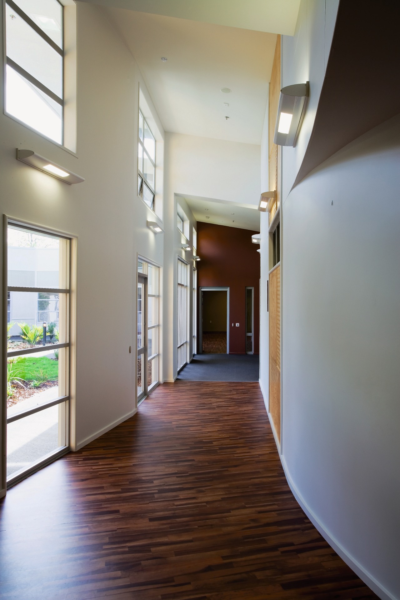 A view of a corridor within the health apartment, architecture, ceiling, daylighting, estate, floor, flooring, hall, hardwood, home, house, interior design, laminate flooring, lobby, loft, real estate, stairs, wood, wood flooring, gray, brown