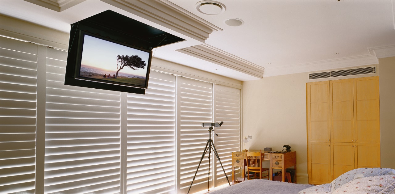 Bedroom with flat screen tv mounted on ceiling. ceiling, daylighting, floor, flooring, home, house, interior design, property, real estate, room, wall, window, window covering, wood, gray