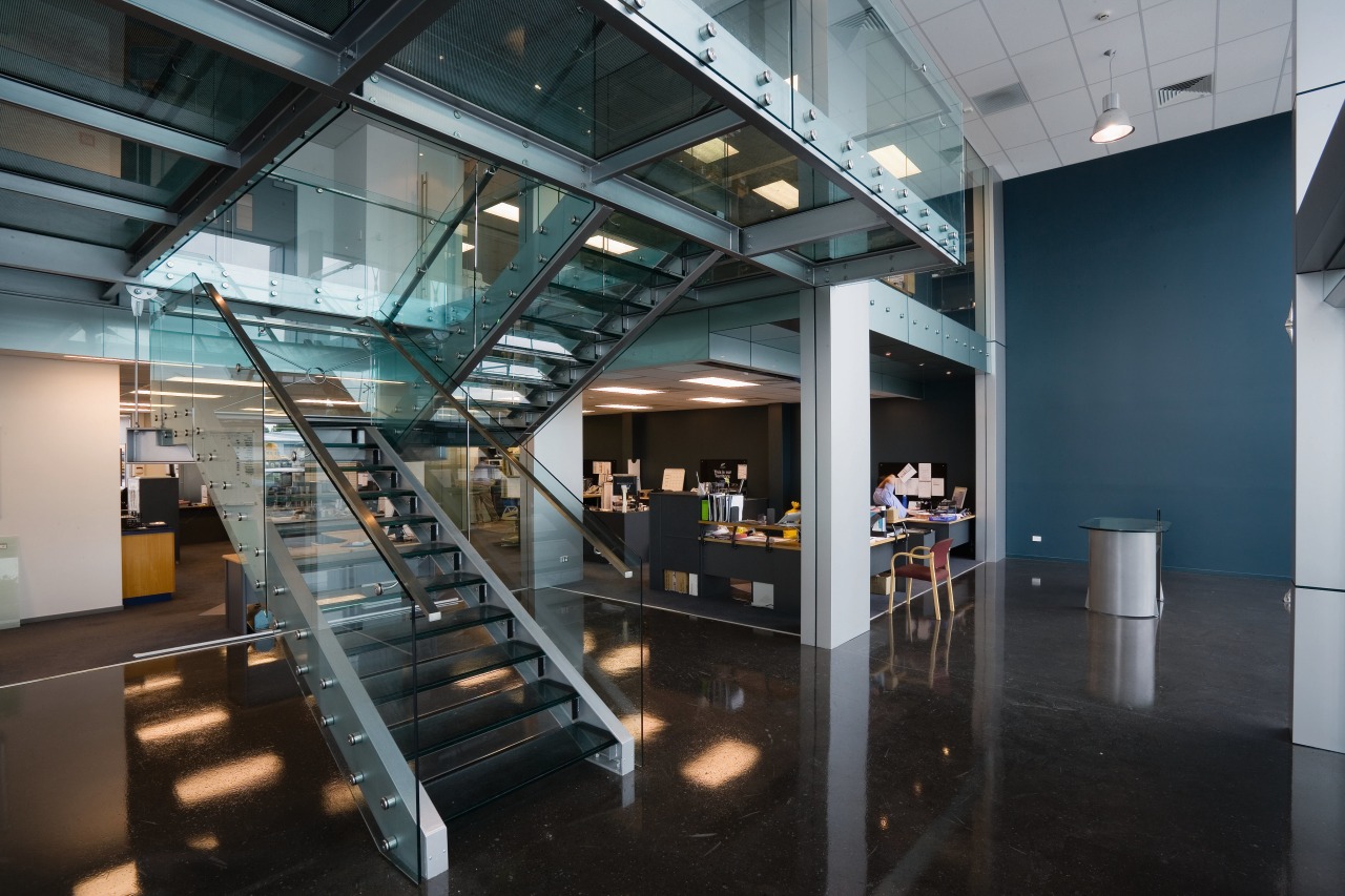 Staircase in office, with glass balustrades, landings and architecture, glass, interior design, lobby, black, gray
