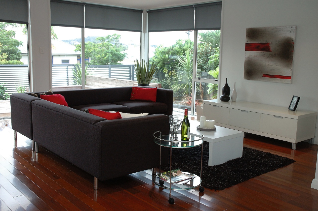 Lounge room with black sofas, and white cabinets. coffee table, couch, floor, furniture, interior design, living room, sofa bed, table, gray, black