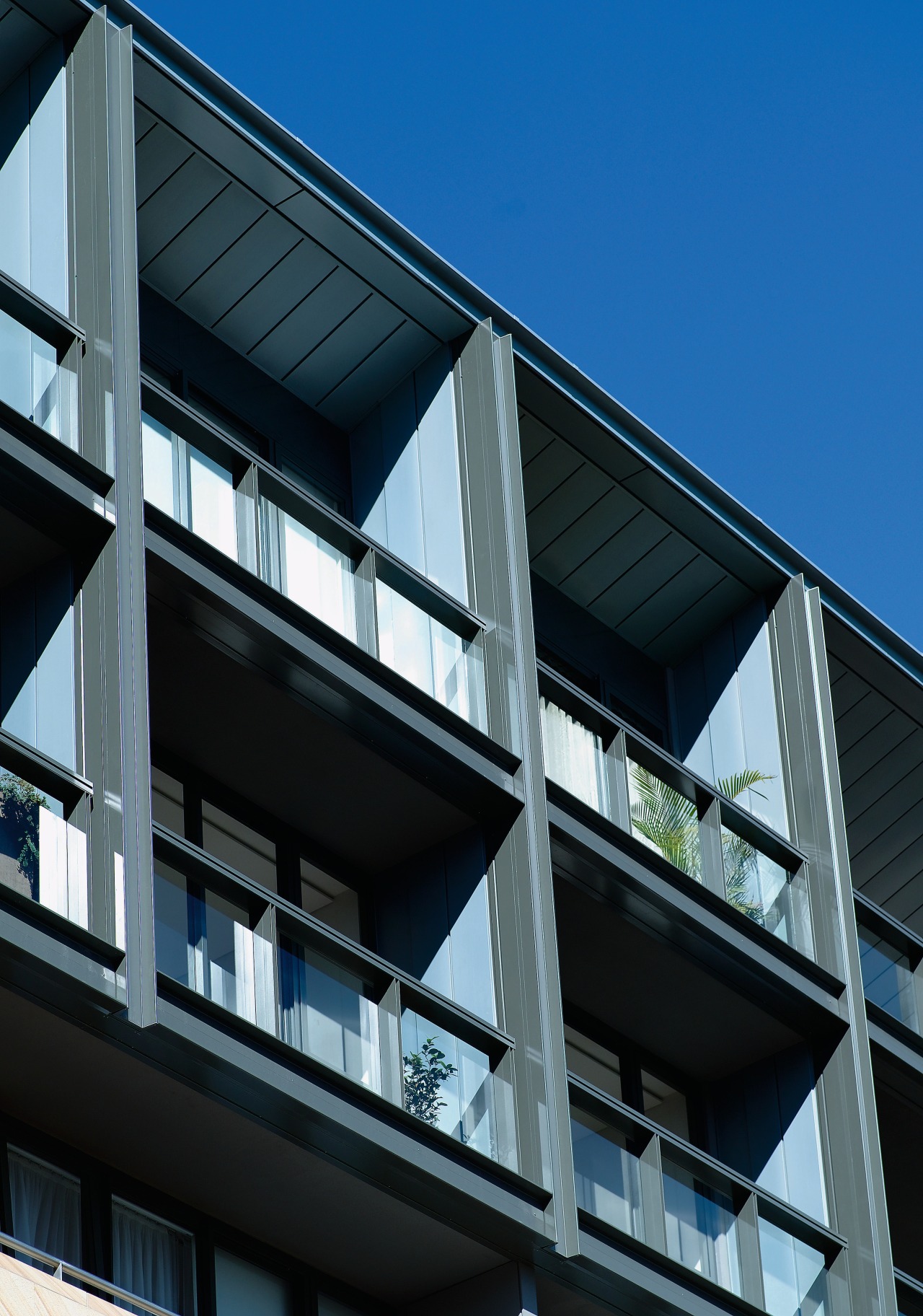 Exterior view of apartment building showing metal titanium apartment, architecture, building, commercial building, condominium, corporate headquarters, daylighting, daytime, facade, glass, headquarters, house, line, metropolitan area, mixed use, residential area, sky, window, black