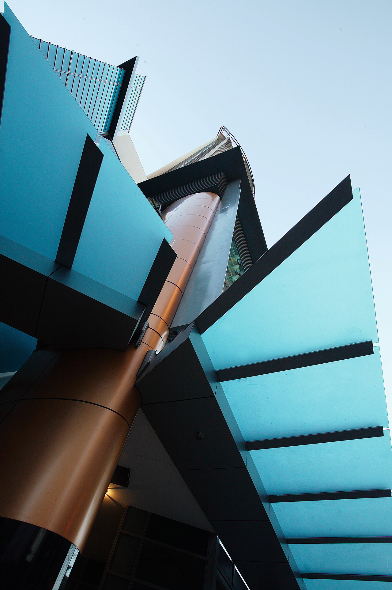 Artistic features at entrance to apartment building. angle, architecture, blue, building, daylighting, daytime, facade, glass, line, product design, sky, structure, black, teal, white