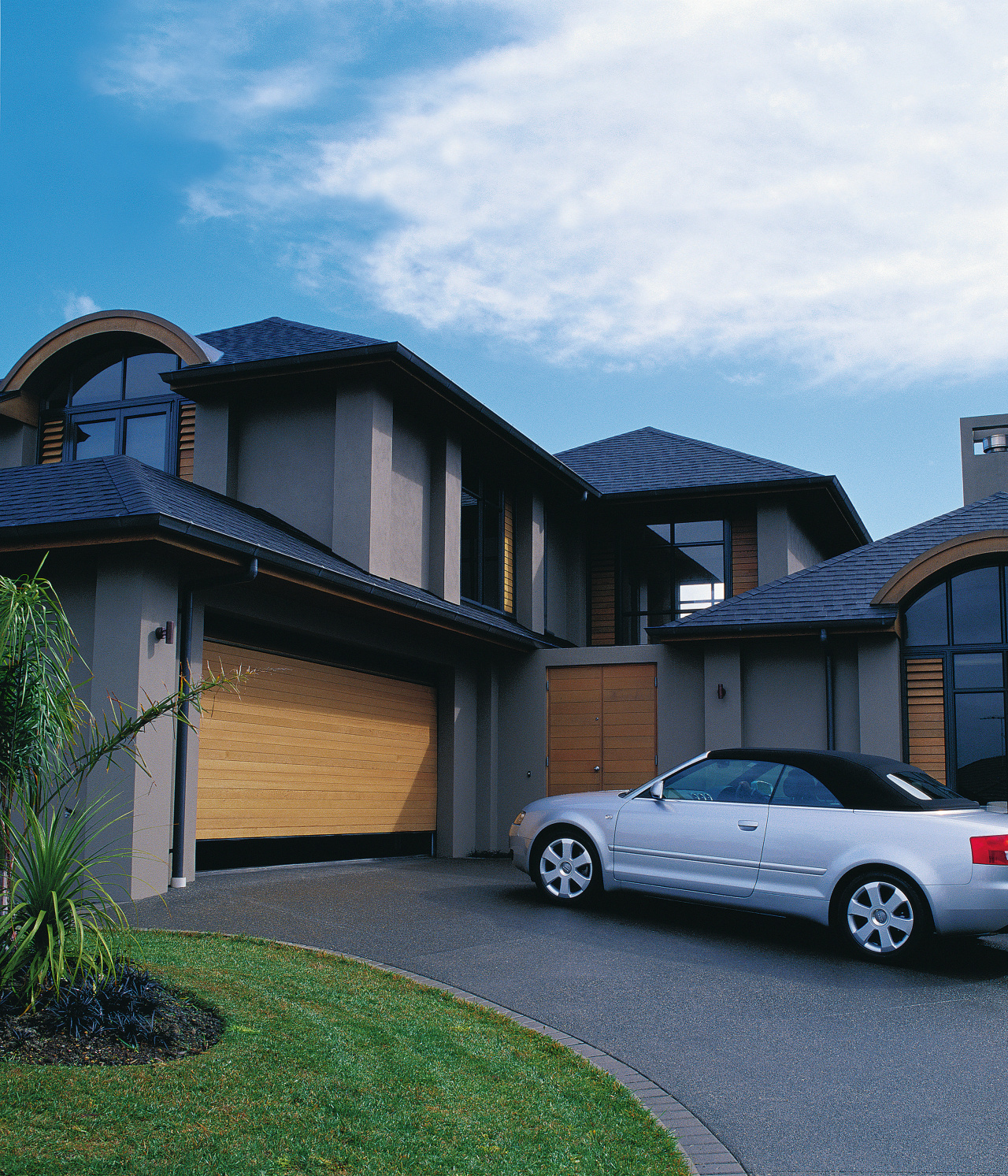 A view of a timber garage door by architecture, automotive exterior, building, car, elevation, estate, facade, family car, home, house, luxury vehicle, mid size car, motor vehicle, property, real estate, residential area, siding, suburb, window