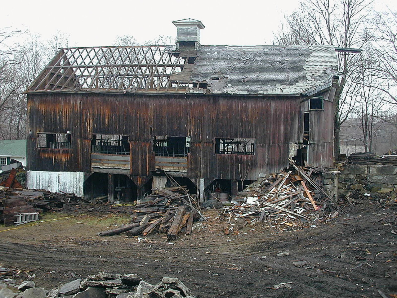 A view of some recliamed antique timber. building, demolition, home, house, log cabin, roof, rural area, shack, shed, wood, black, gray, white