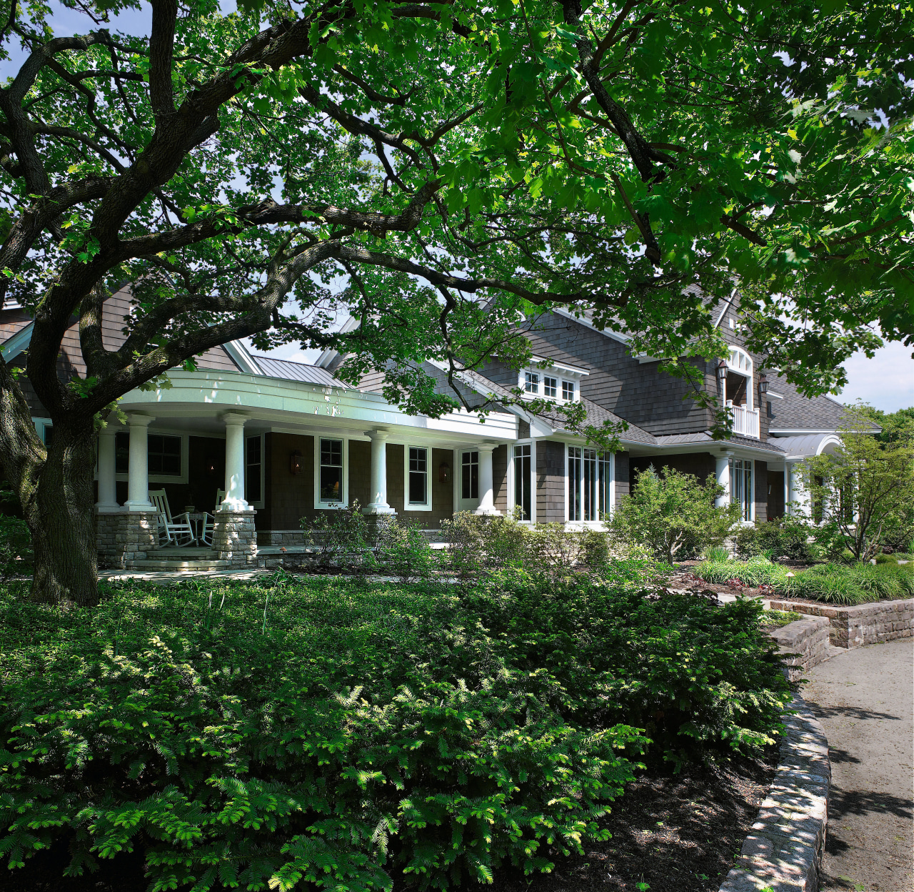 An exterior view of the driveway and entrance architecture, backyard, cottage, estate, farmhouse, garden, historic house, home, house, mansion, neighbourhood, outdoor structure, plant, plantation, property, real estate, residential area, tree, yard, green