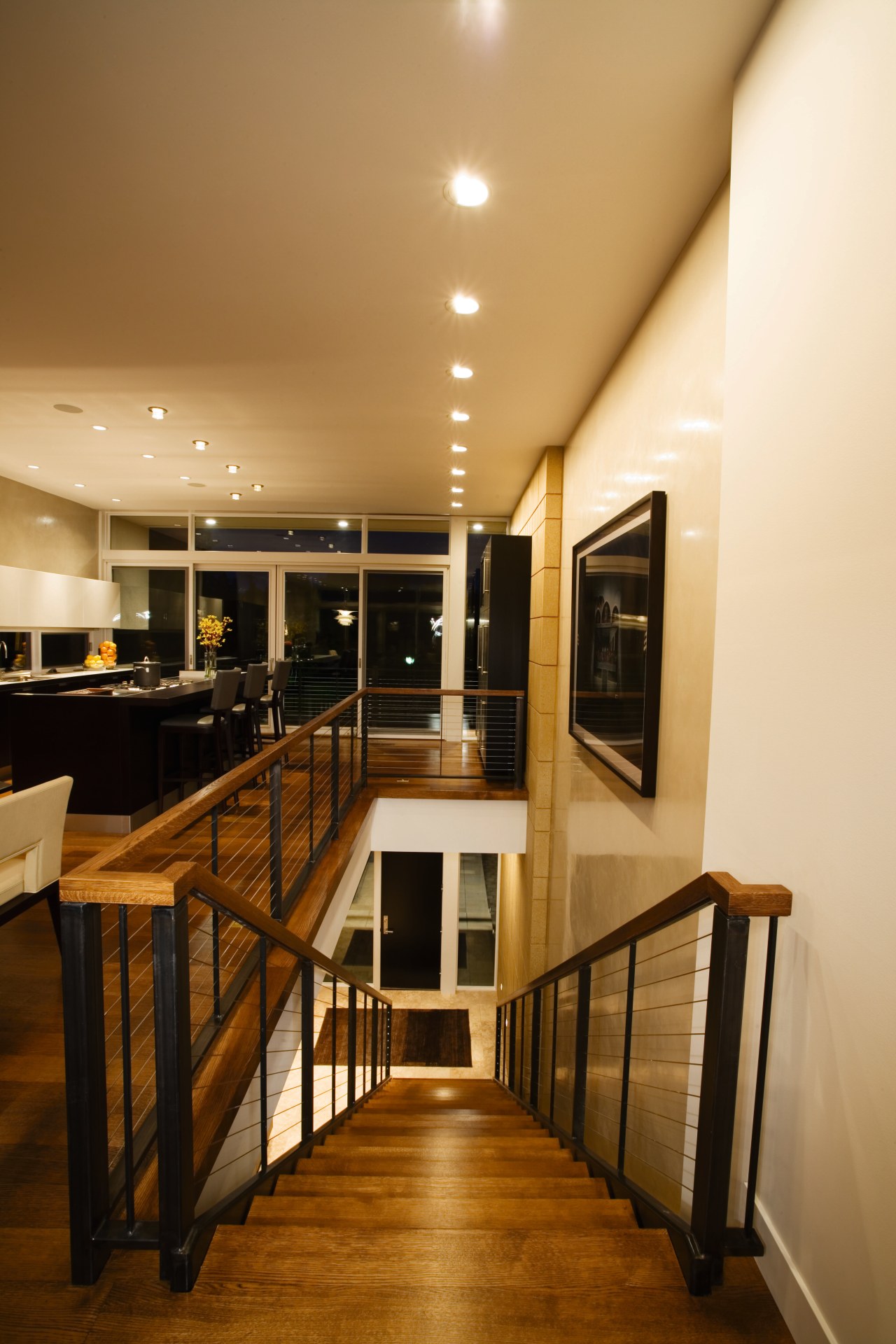 A view of a home designed by Streeter ceiling, floor, flooring, furniture, handrail, interior design, lighting, room, table, wood, orange, brown