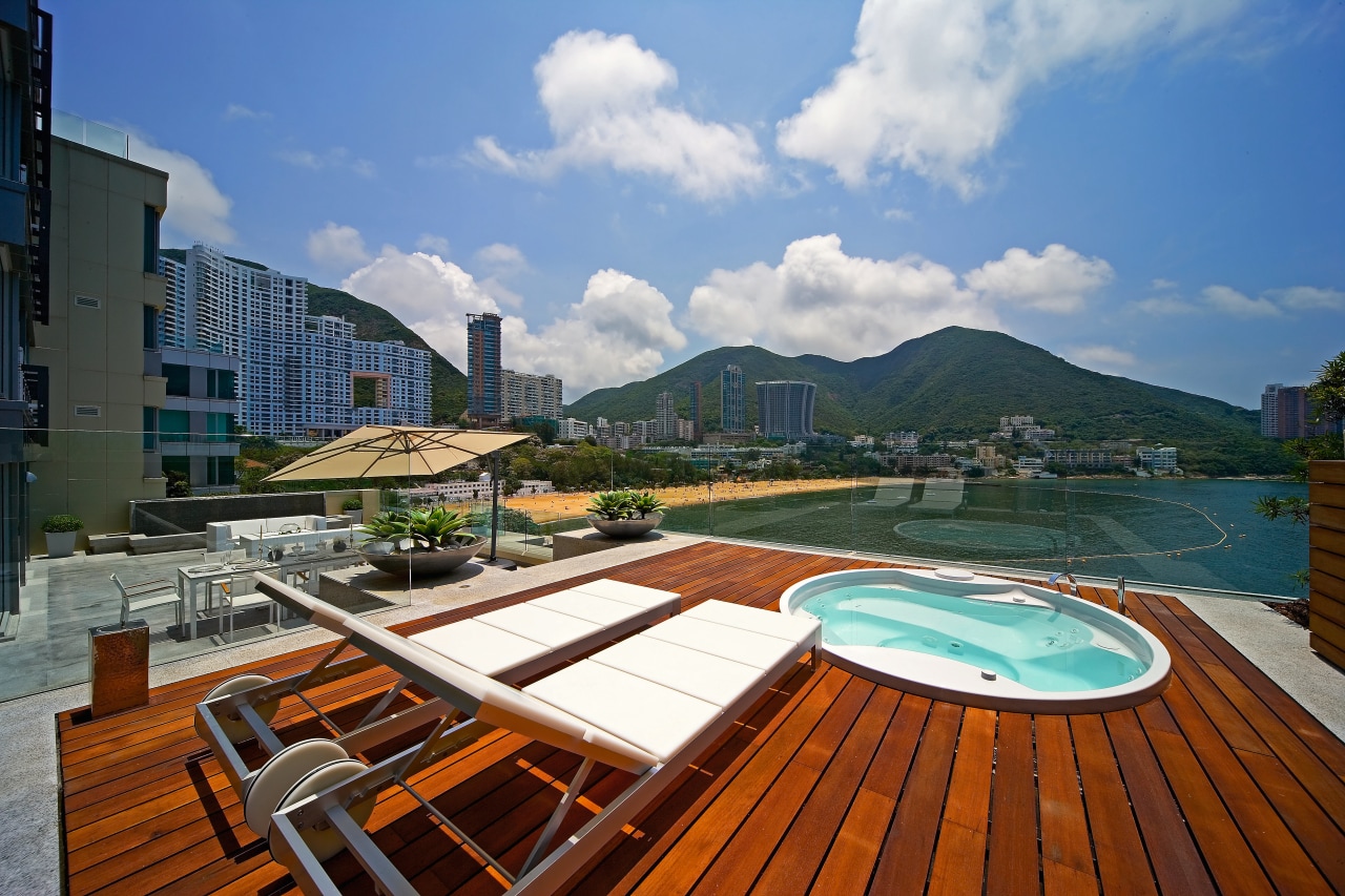 An exterior view of the spa pool area. apartment, condominium, estate, home, leisure, property, real estate, resort, roof, sky, swimming pool, water, teal