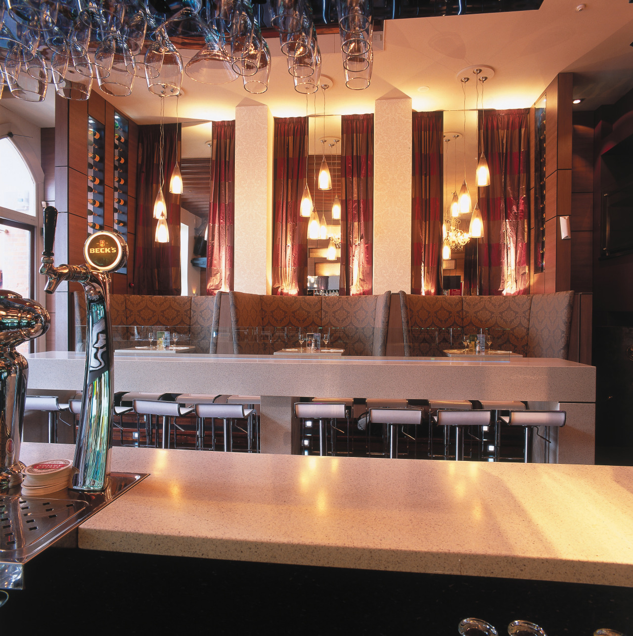 view of the bar and seating areas featuring countertop, interior design, lighting, restaurant, orange