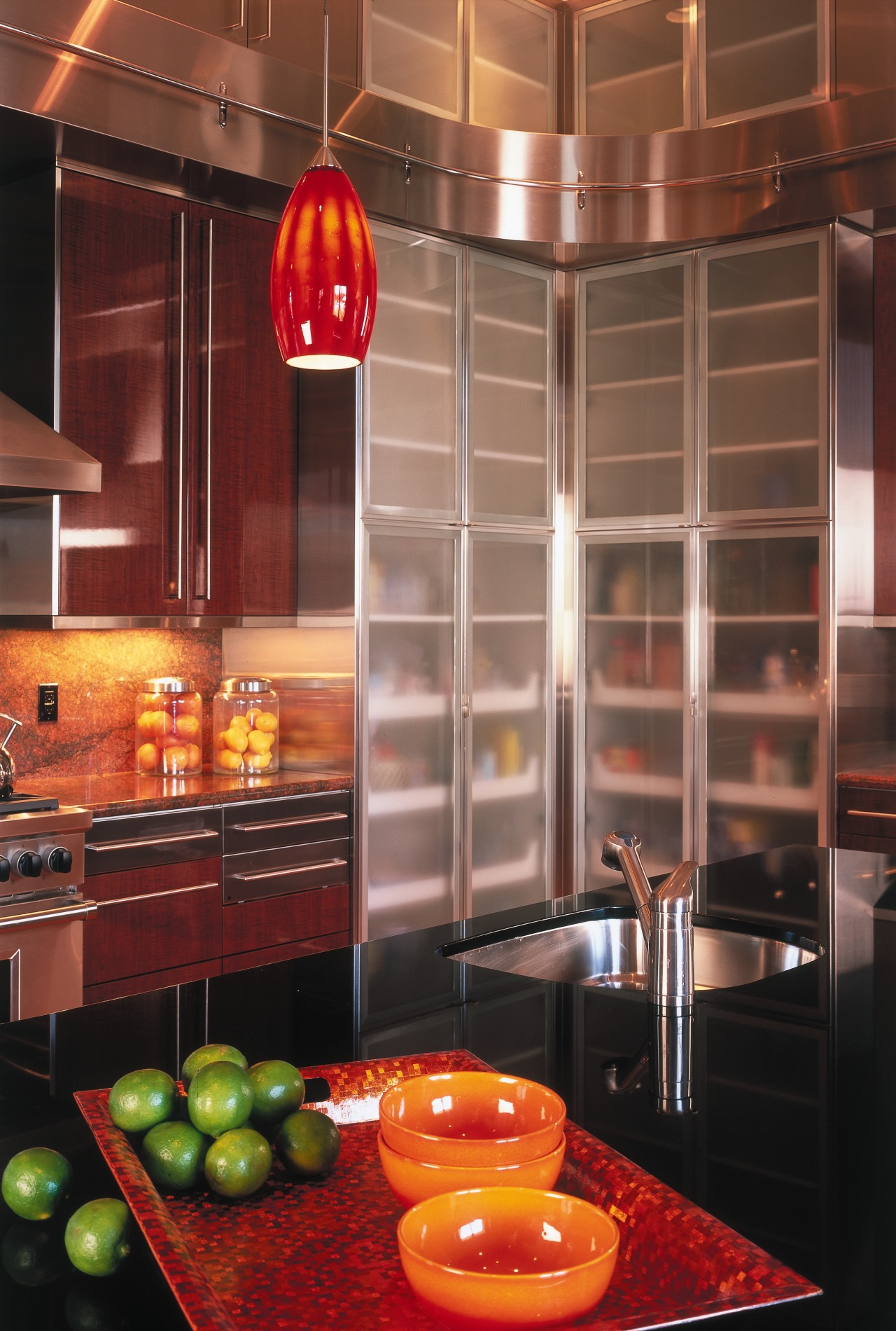 A view of the kitchen, wooden and glass cabinetry, ceiling, countertop, interior design, kitchen, light fixture, lighting, orange, room, under cabinet lighting, red, brown