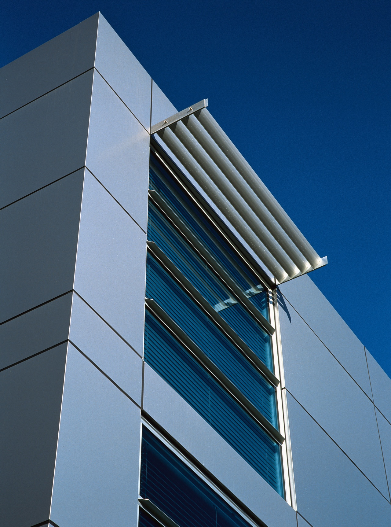 A view of a home by ADNZ. angle, architecture, building, commercial building, corporate headquarters, daylighting, daytime, facade, headquarters, line, sky, skyscraper, structure, tower block, urban area, blue, teal