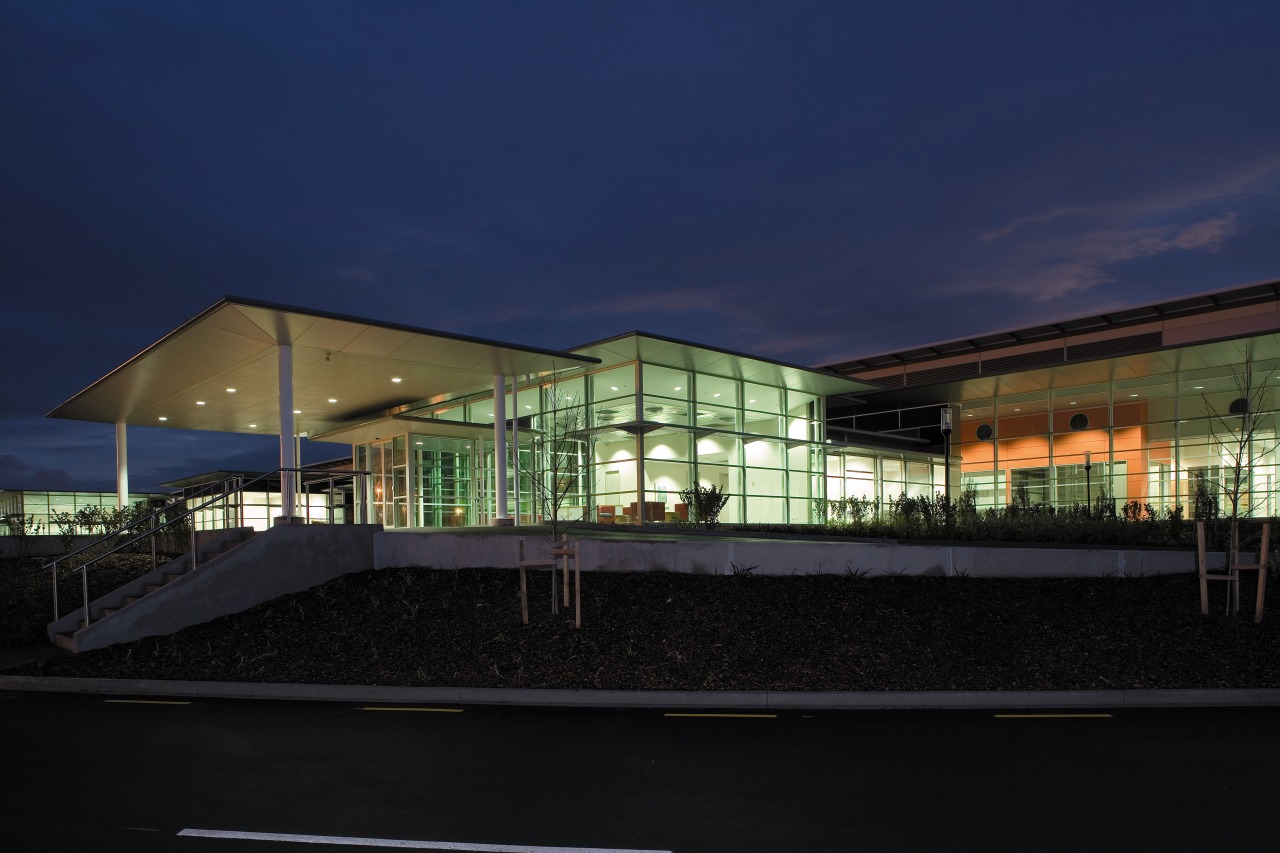 An exterior view of the enitre Fiaher &amp; architecture, building, corporate headquarters, daylighting, estate, evening, facade, headquarters, home, house, lighting, mixed use, night, real estate, reflection, residential area, sky, black, blue