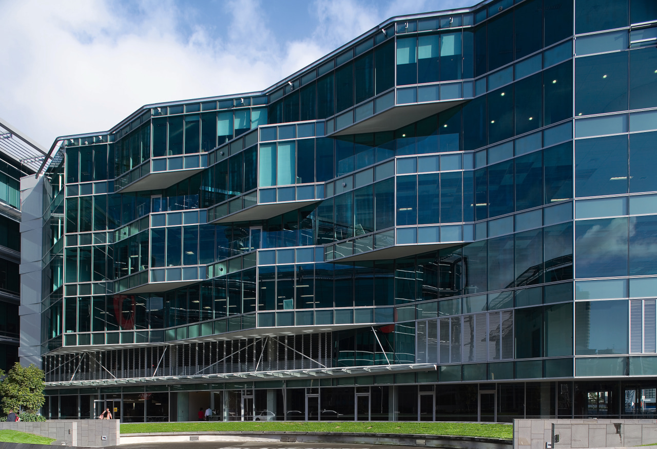 An exterior view of the Microsoft building. apartment, architecture, building, commercial building, condominium, corporate headquarters, daytime, facade, headquarters, metropolis, metropolitan area, mixed use, residential area, sky, blue, black