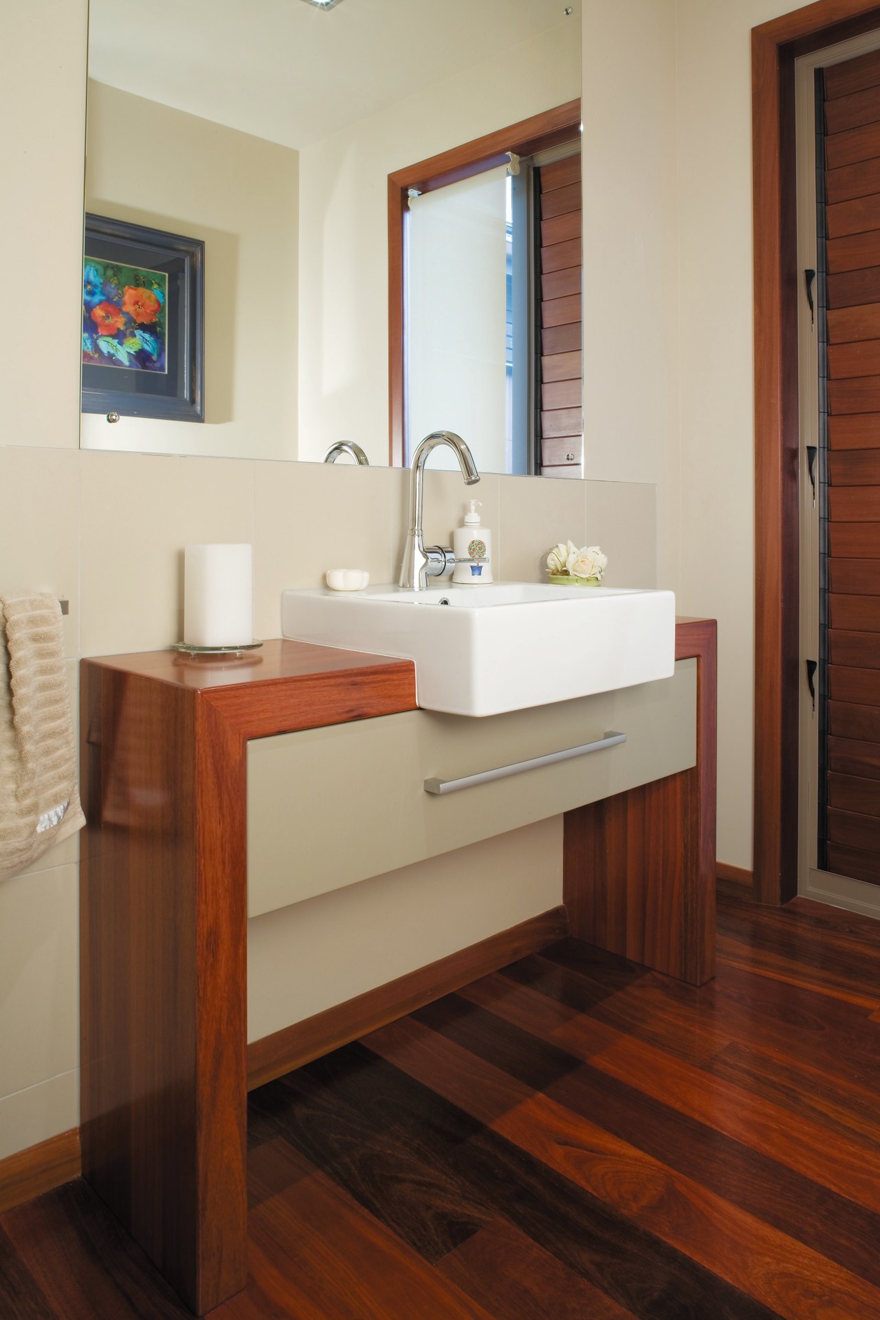 A view of some cabnetry by Carlielle Kitchens. bathroom, bathroom accessory, bathroom cabinet, floor, flooring, furniture, hardwood, interior design, laminate flooring, room, sink, wood, wood flooring, gray, brown