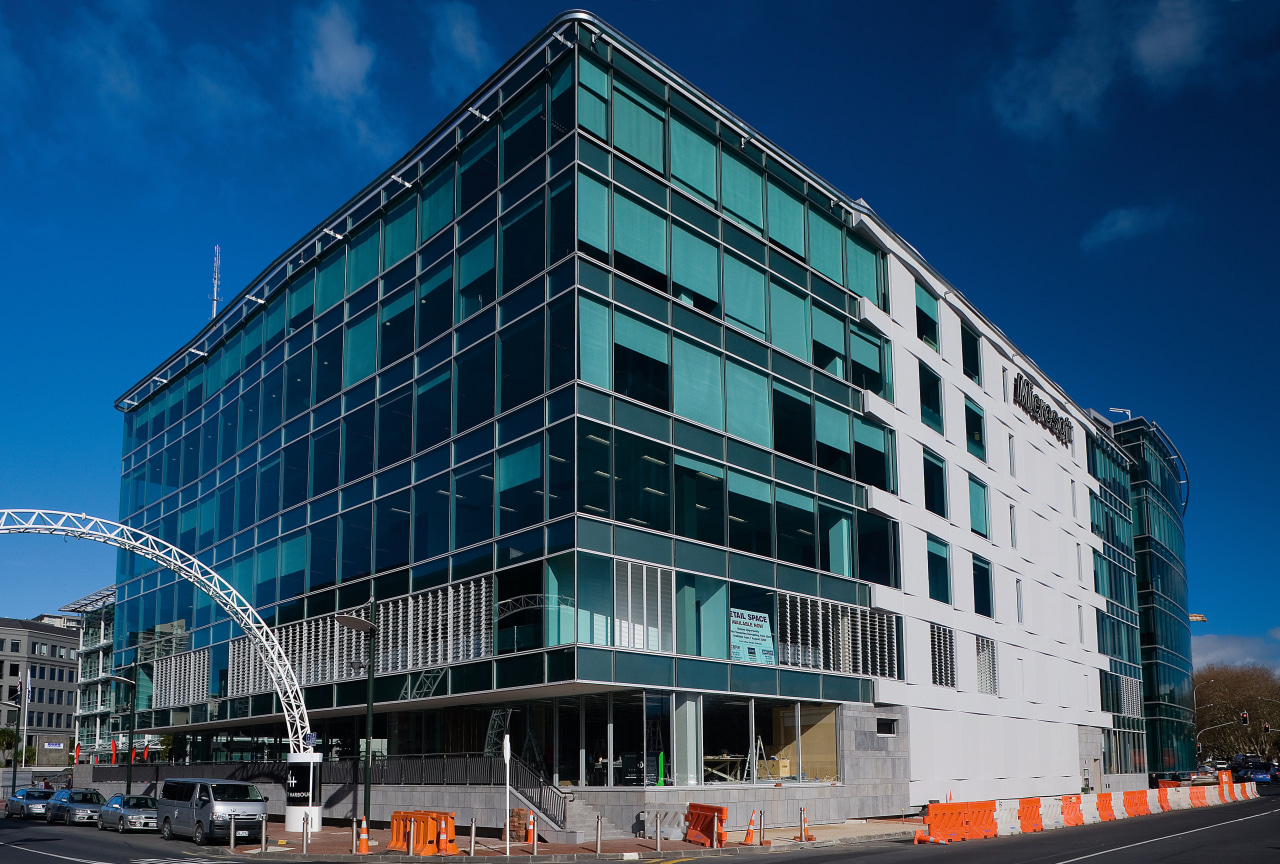 An exterior view of the Microsoft building. apartment, architecture, building, city, commercial building, condominium, corporate headquarters, daytime, downtown, facade, headquarters, house, metropolis, metropolitan area, mixed use, neighbourhood, residential area, sky, skyscraper, tower block, urban area, blue