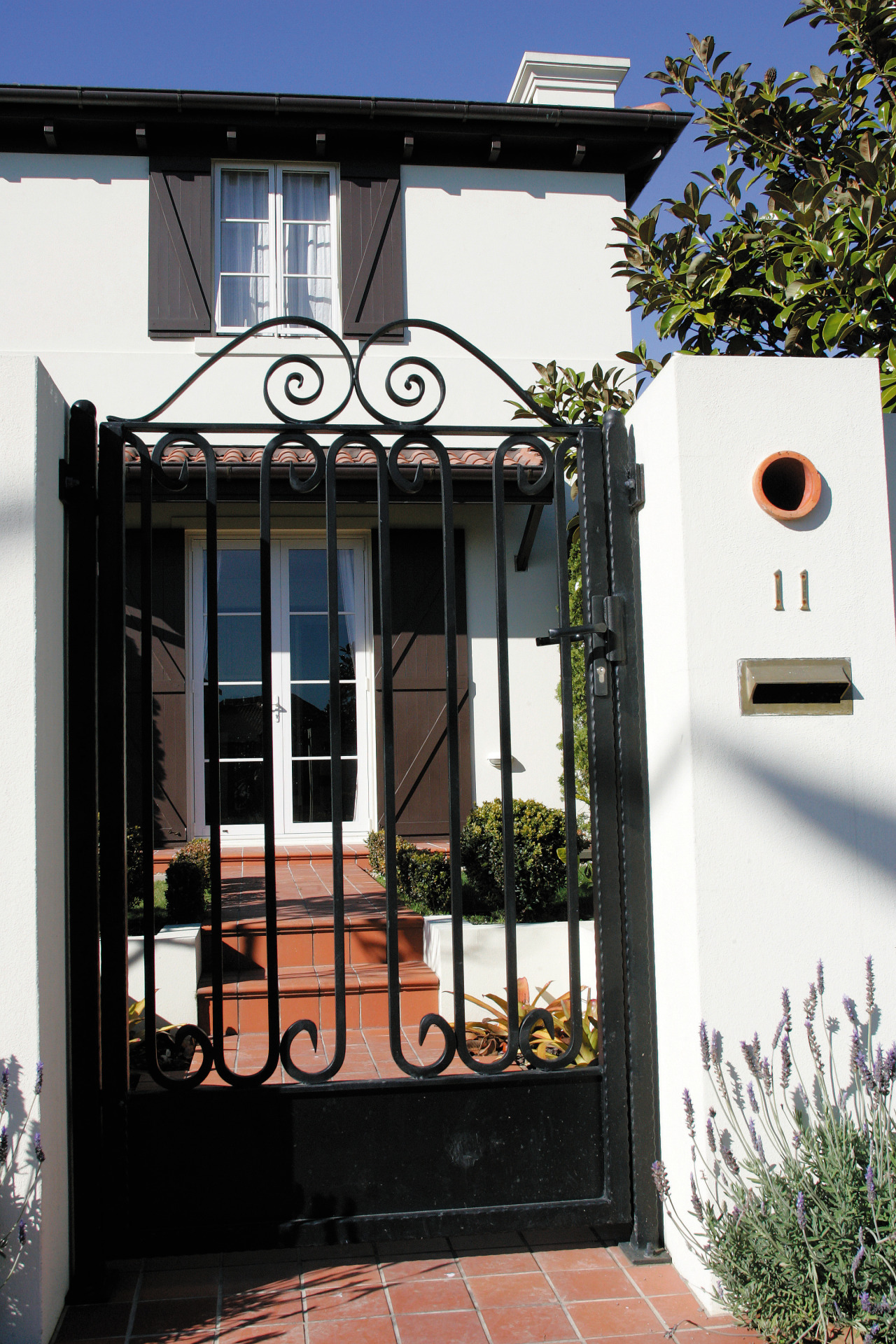 A view o a home by Eden Homes. door, facade, gate, home, house, iron, neighbourhood, property, residential area, window, black, white