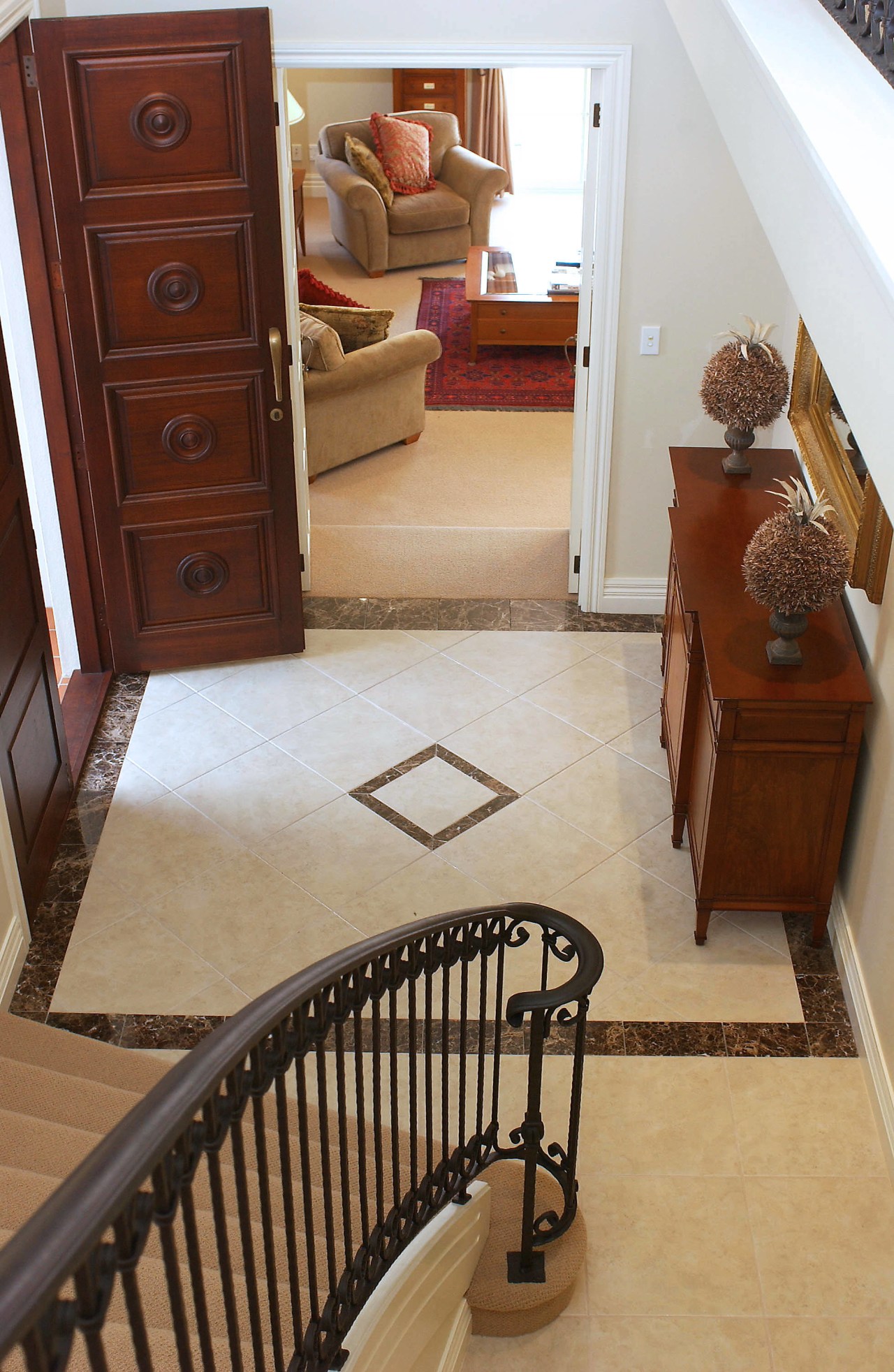 A view of a home by Eden Homes. floor, flooring, furniture, handrail, hardwood, home, interior design, laminate flooring, living room, product, room, stairs, tile, wall, wood, wood flooring, wood stain, brown