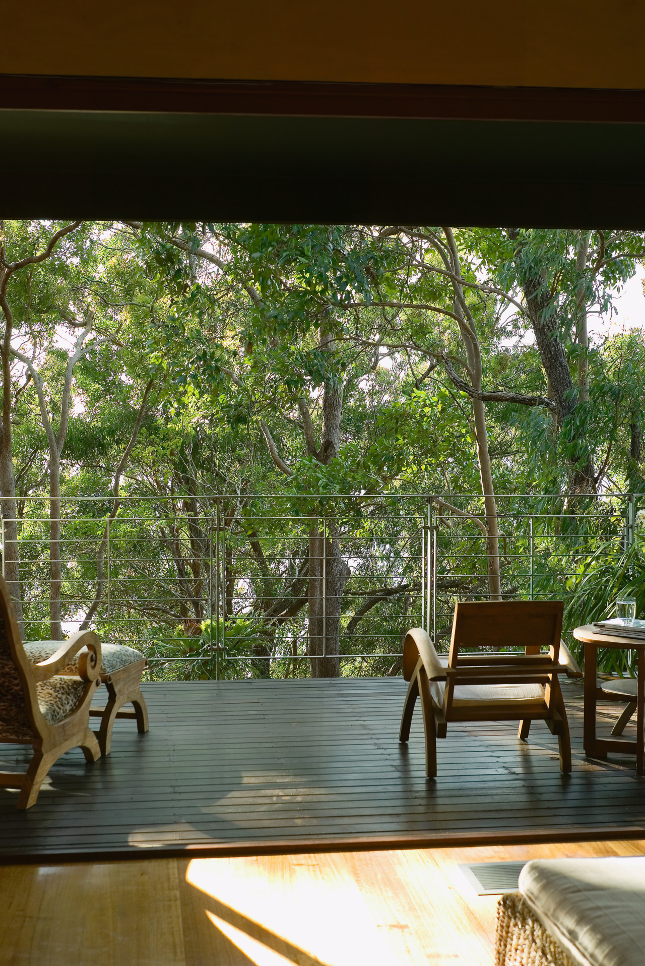 view from the ouitdoor balcony looking out into furniture, home, house, interior design, living room, outdoor furniture, outdoor structure, plant, table, tree, window, wood, brown