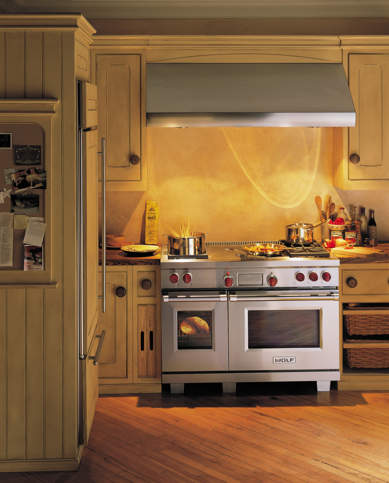 A view of a kitchen with Goldman Associates cabinetry, countertop, cuisine classique, floor, flooring, hardwood, home, home appliance, interior design, kitchen, kitchen appliance, kitchen stove, major appliance, microwave oven, oven, room, under cabinet lighting, brown