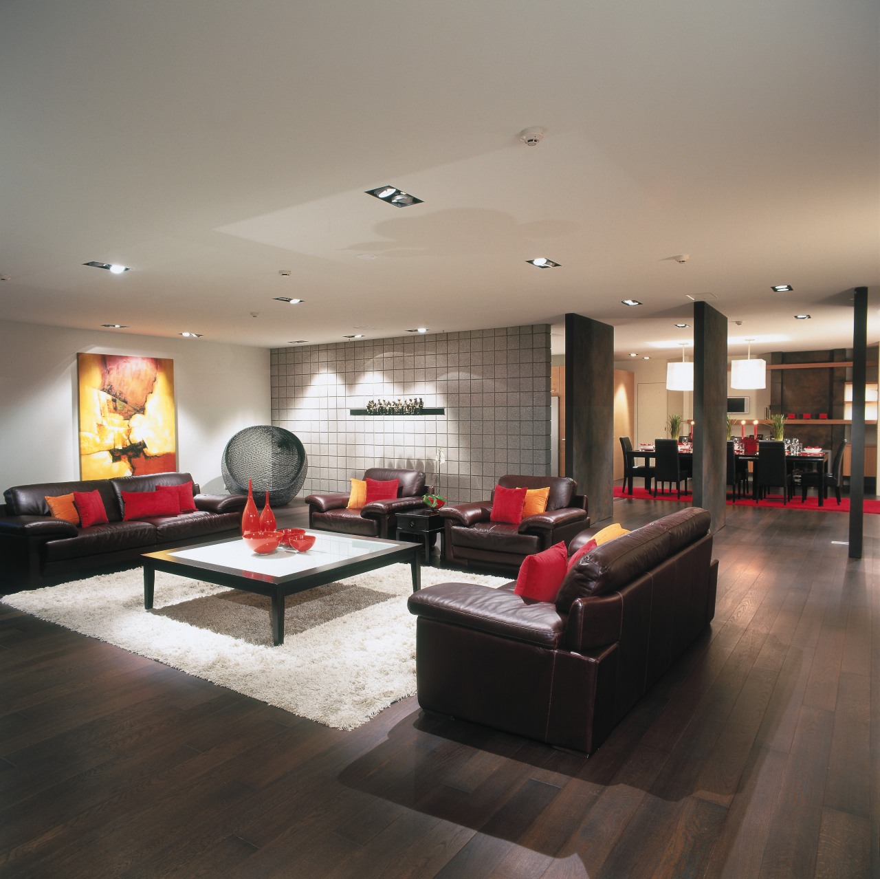 view of the lounge area featuring darked stained ceiling, floor, flooring, interior design, living room, lobby, room, table, wood flooring, gray, black