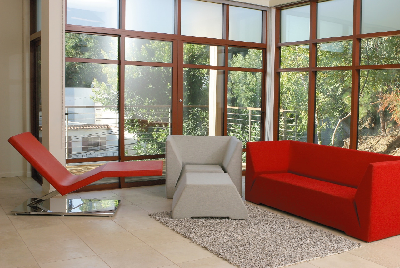 view of this minimalist lounge featuring a white chair, couch, floor, furniture, interior design, living room, property, real estate, window, gray