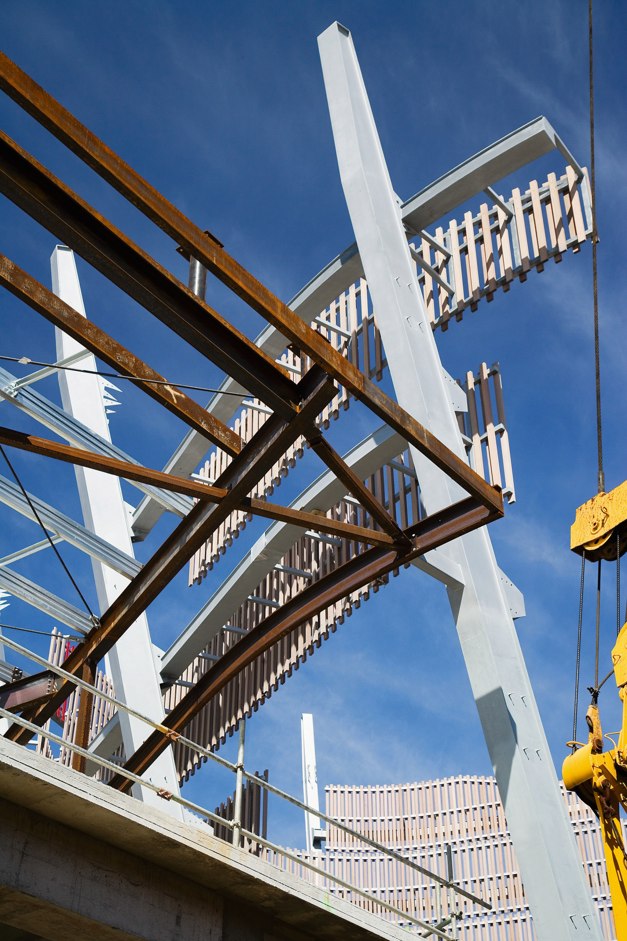 A view of a structure by Auckland Steel. architecture, bridge, building, cable stayed bridge, fixed link, girder bridge, landmark, sky, structure, windmill, blue