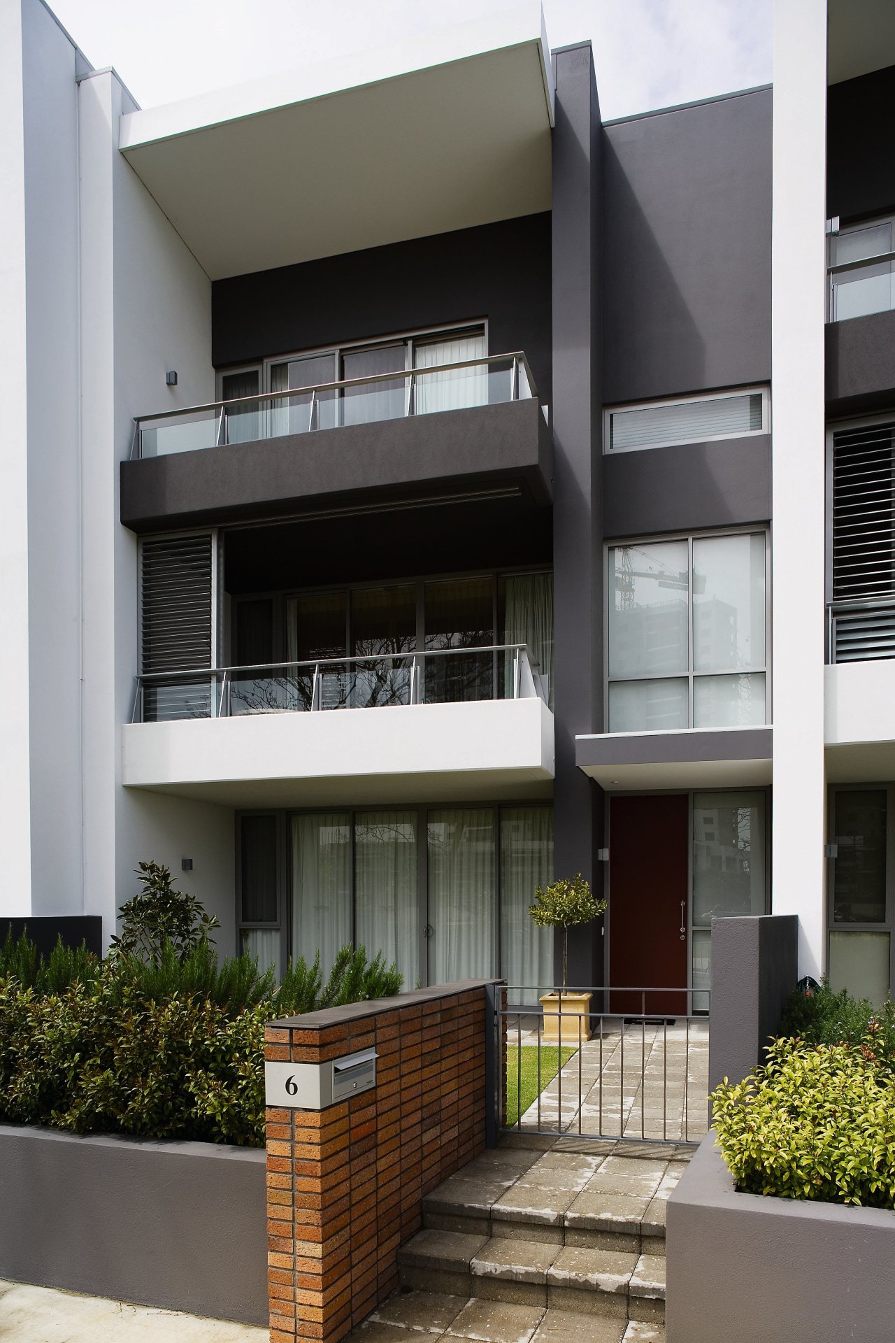 view of the apartment development featuring the high apartment, architecture, balcony, building, commercial building, condominium, elevation, facade, home, house, mixed use, real estate, residential area, window, black, gray