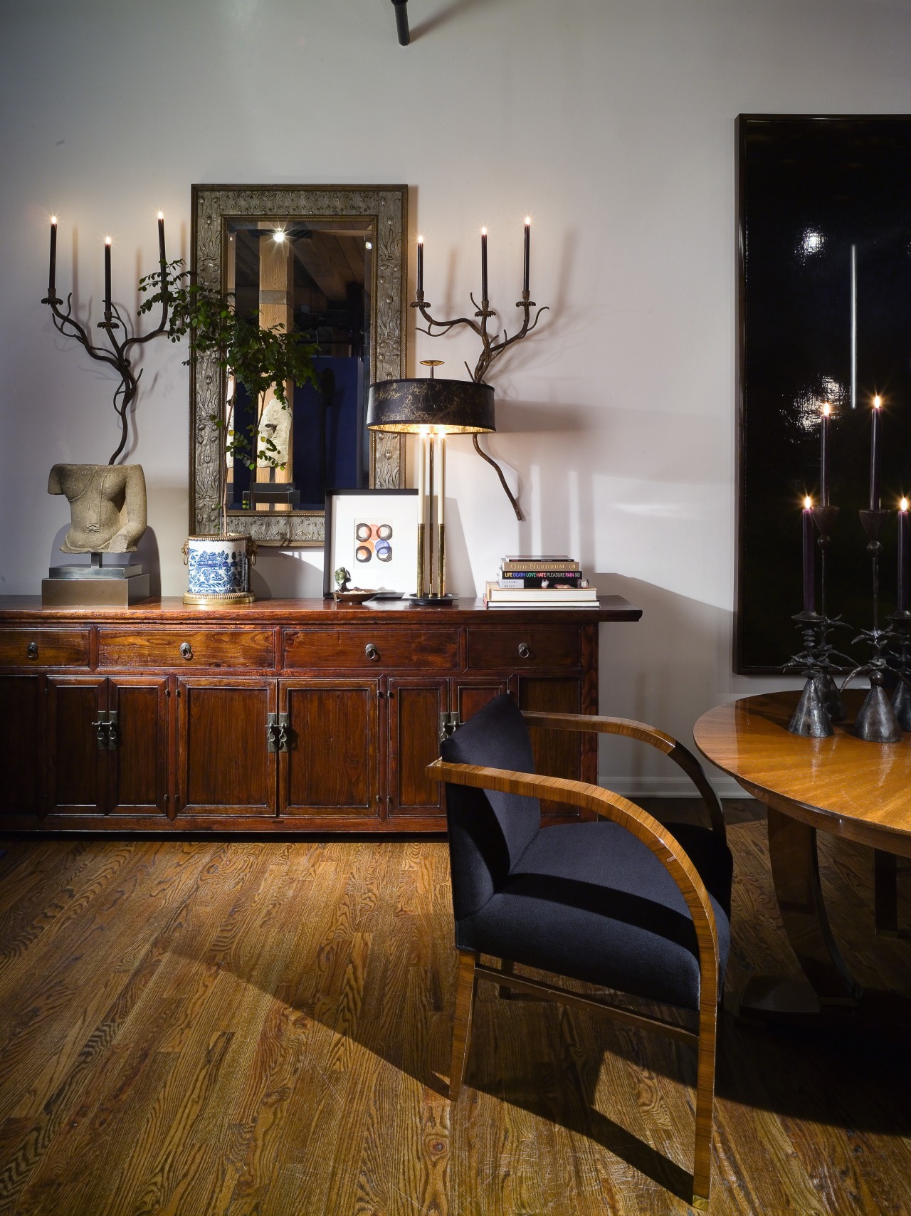 View of dining area inside house with interior cabinetry, chair, chest of drawers, dining room, floor, flooring, furniture, hardwood, home, interior design, living room, room, table, wood, wood flooring, gray, black, brown