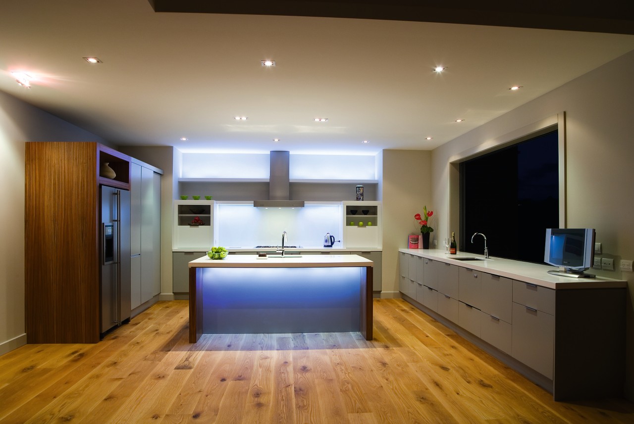 A view of some kitchen cabinetry by The ceiling, floor, flooring, interior design, kitchen, lighting, living room, real estate, room, wood flooring, brown