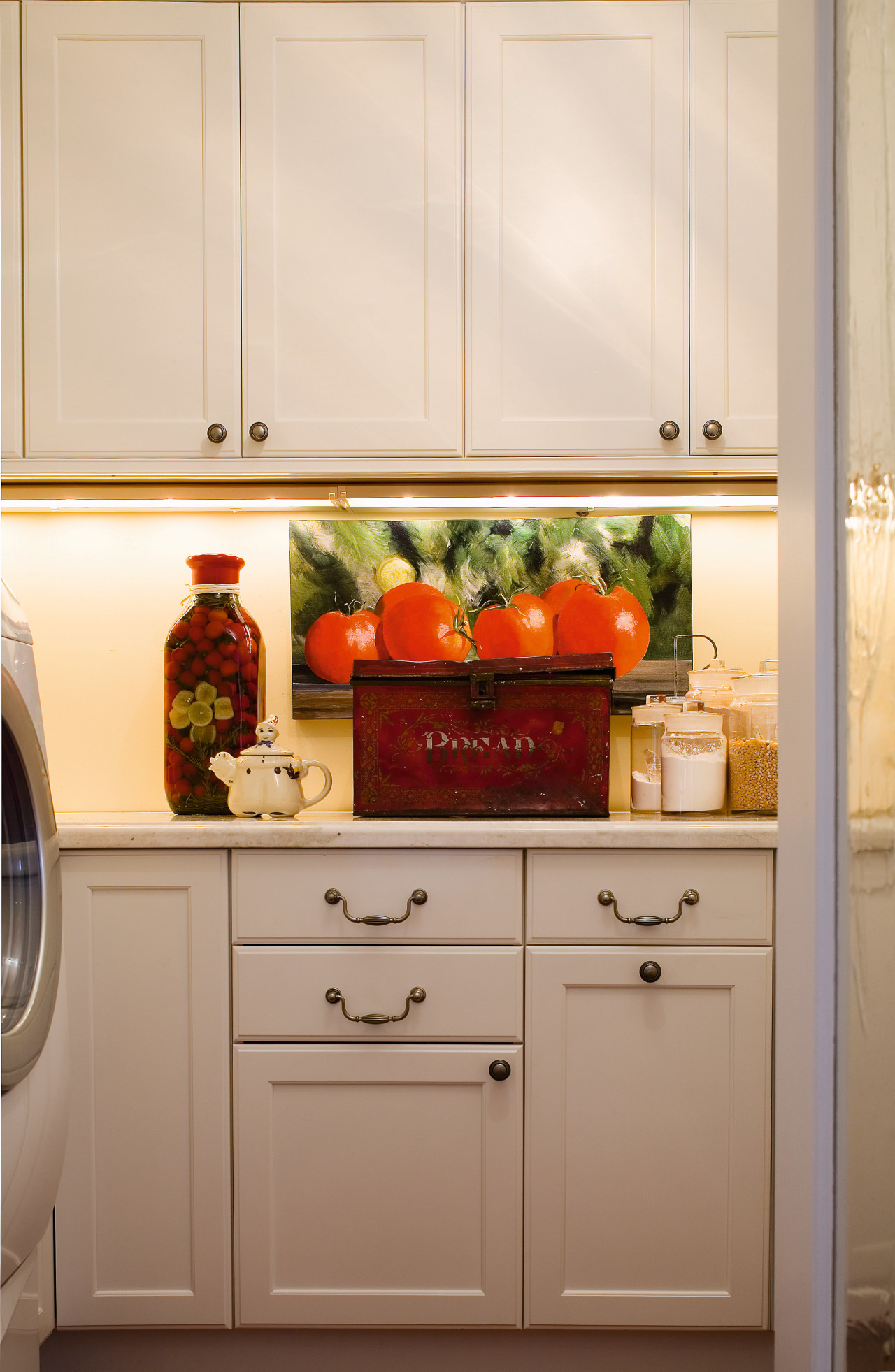 A close up view of the kitchen cabinetry. cabinetry, countertop, home appliance, interior design, kitchen, kitchen appliance, major appliance, refrigerator, room, orange, brown