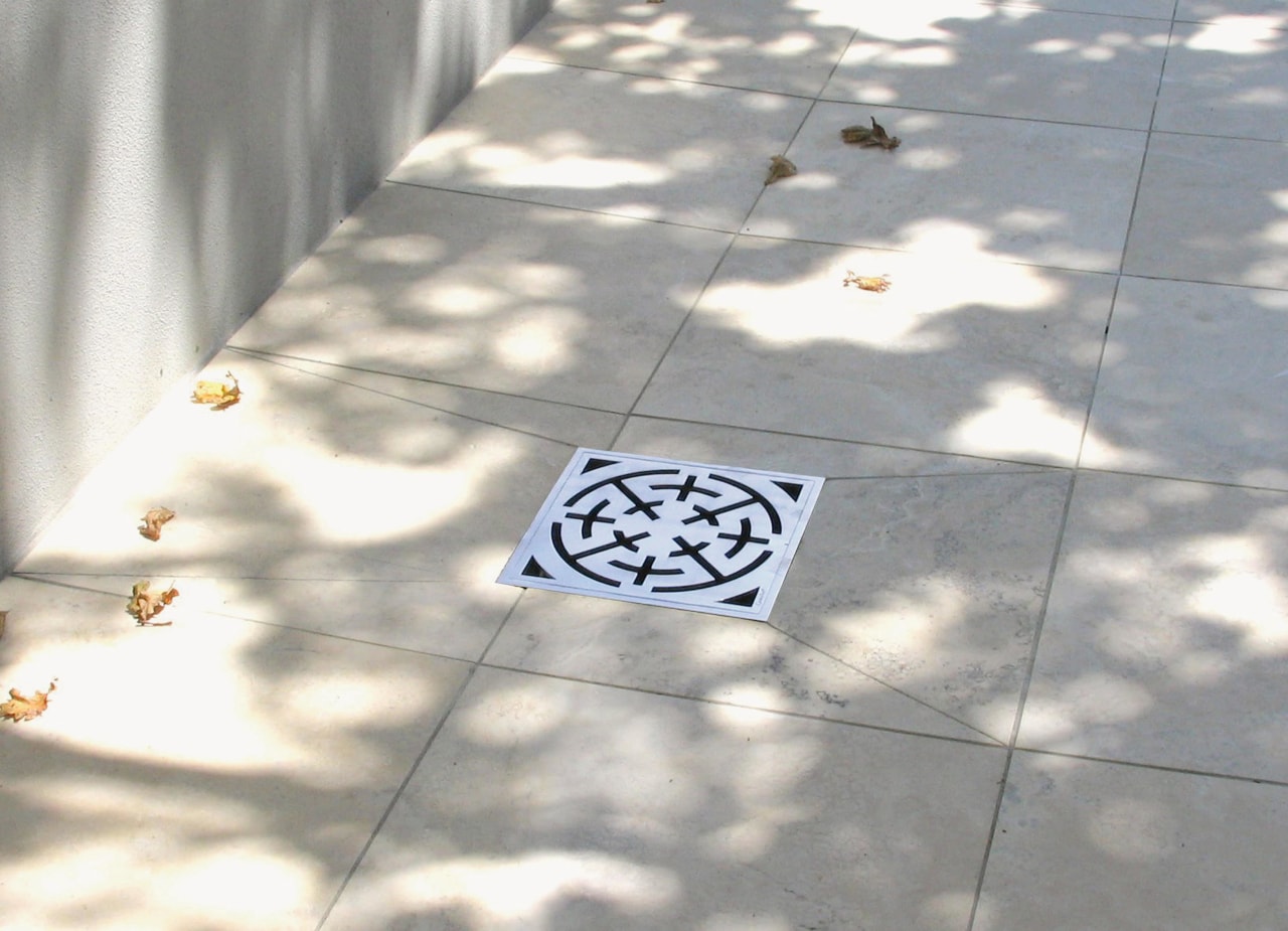 A view of some swimming pool grates. floor, font, line, pattern, road surface, gray, white