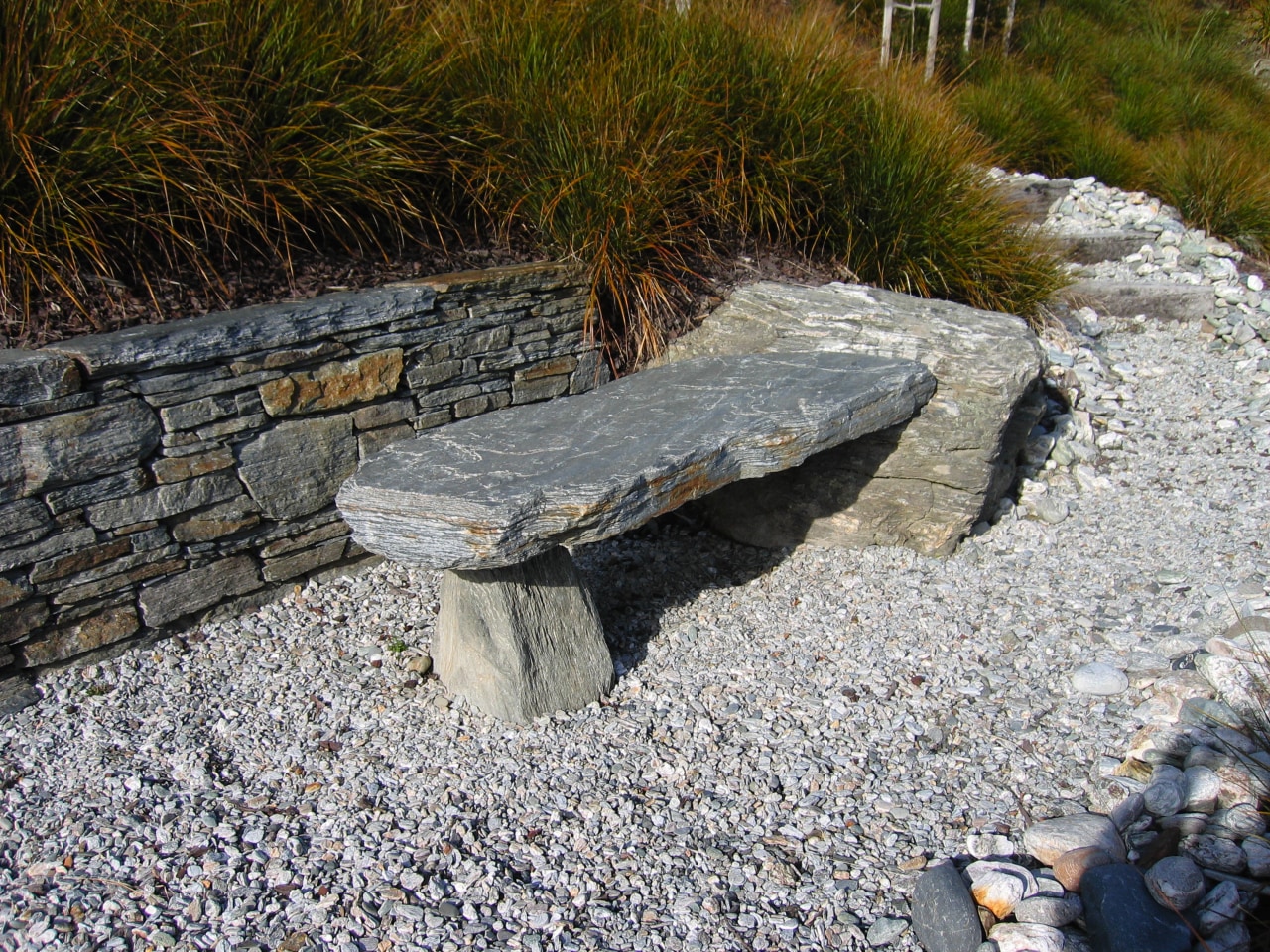 A view of some landscaping by LIANZ. bedrock, boulder, landscape, outcrop, rock, rubble, stone wall, stream bed, walkway, wall, gray, brown