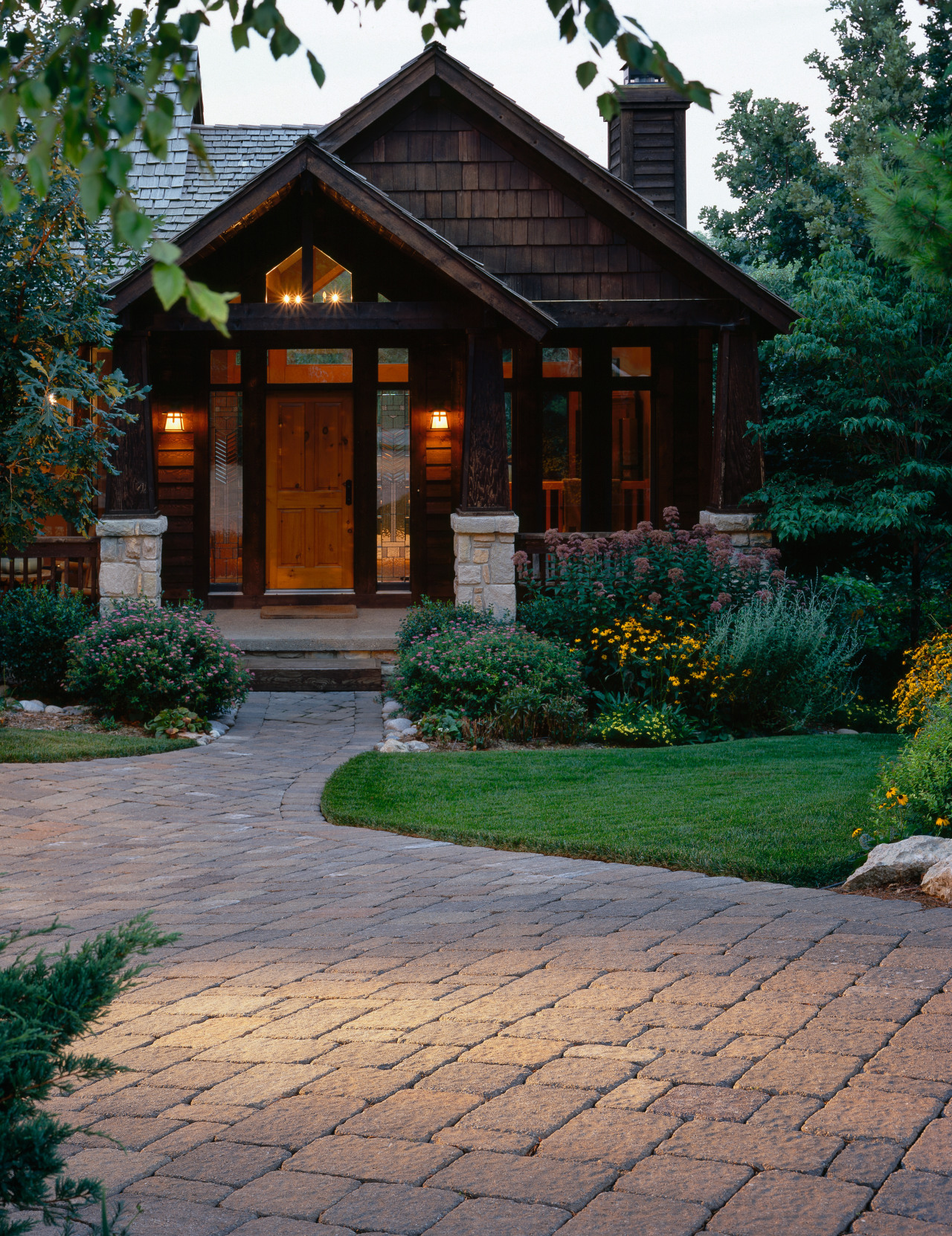 View of traditionally styled home with shingle cladding, backyard, cottage, driveway, estate, facade, garden, home, house, landscape, landscaping, outdoor structure, real estate, shed, siding, walkway, wood, yard