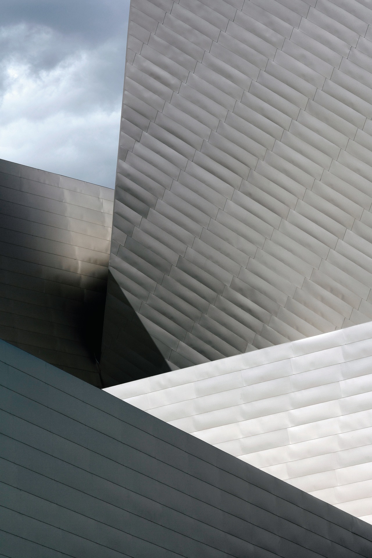 A view of Devers new Cultural Centre witch angle, architecture, building, cloud, daylighting, daytime, facade, house, line, roof, sky, structure, wall, window, wood, gray, black