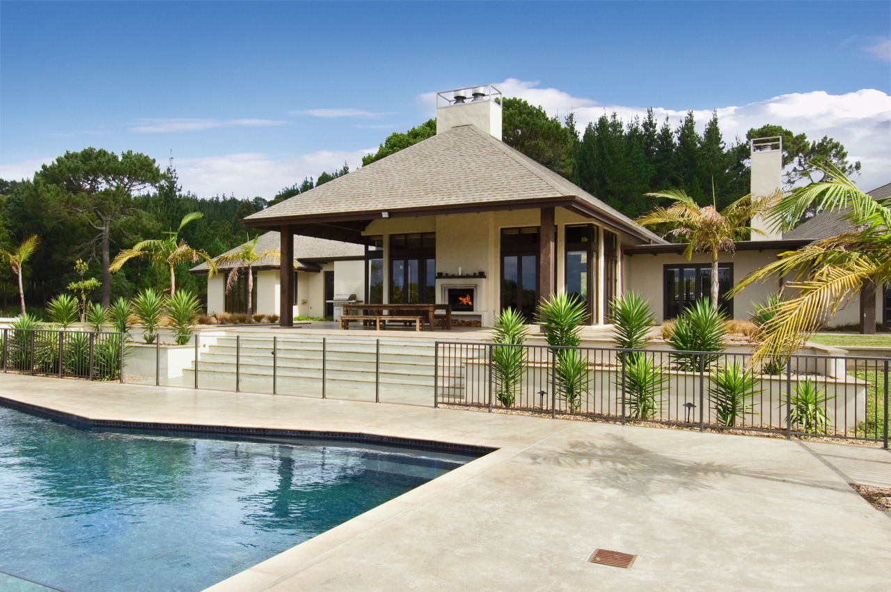 A vie wof some pavers by Peter Fell. arecales, backyard, cottage, elevation, estate, facade, hacienda, home, house, mansion, outdoor structure, palm tree, property, real estate, resort, swimming pool, villa, white, teal