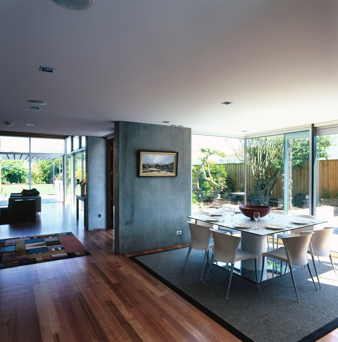 A interior view of the dining area featuring architecture, ceiling, daylighting, floor, flooring, hardwood, house, interior design, living room, real estate, window, wood flooring, gray