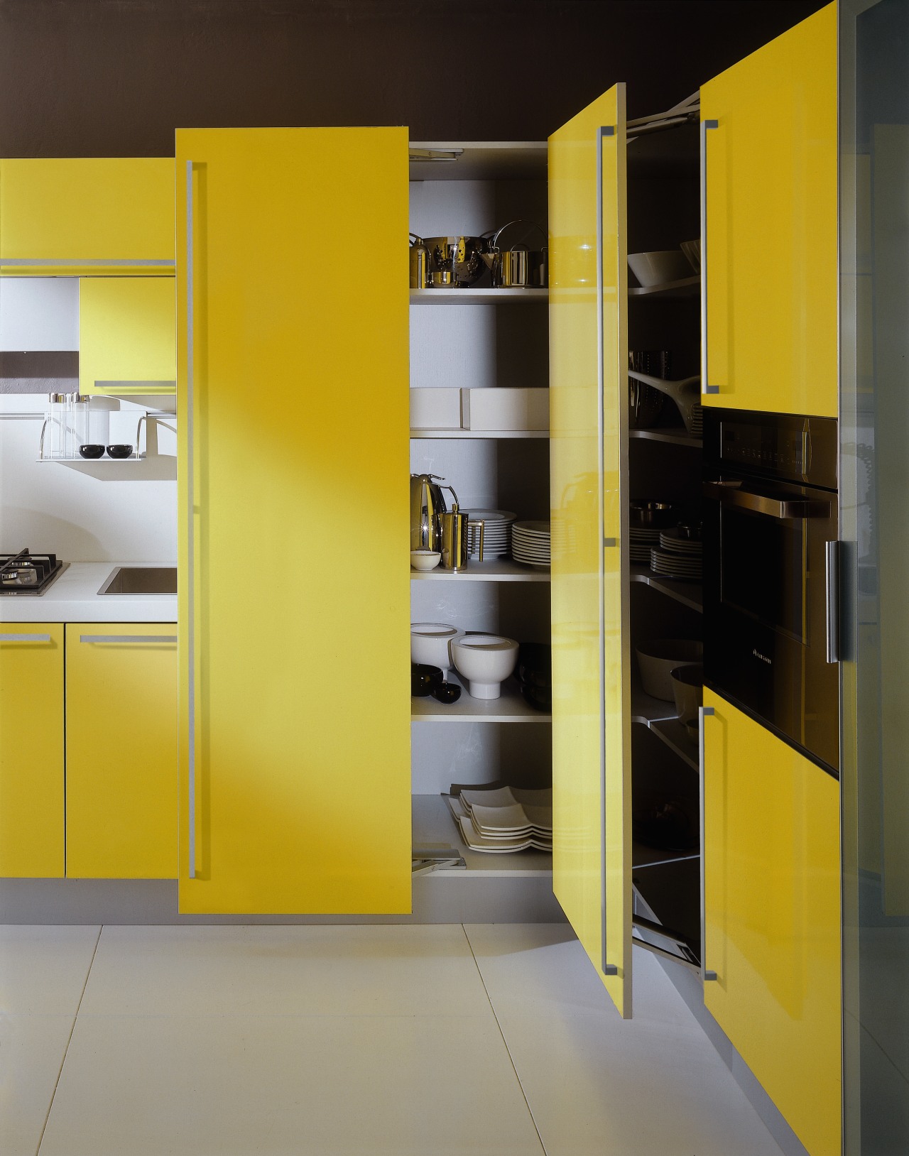 View of this clean lined kitchen featuring bright angle, architecture, furniture, interior design, kitchen, product design, shelf, shelving, yellow, gray, black