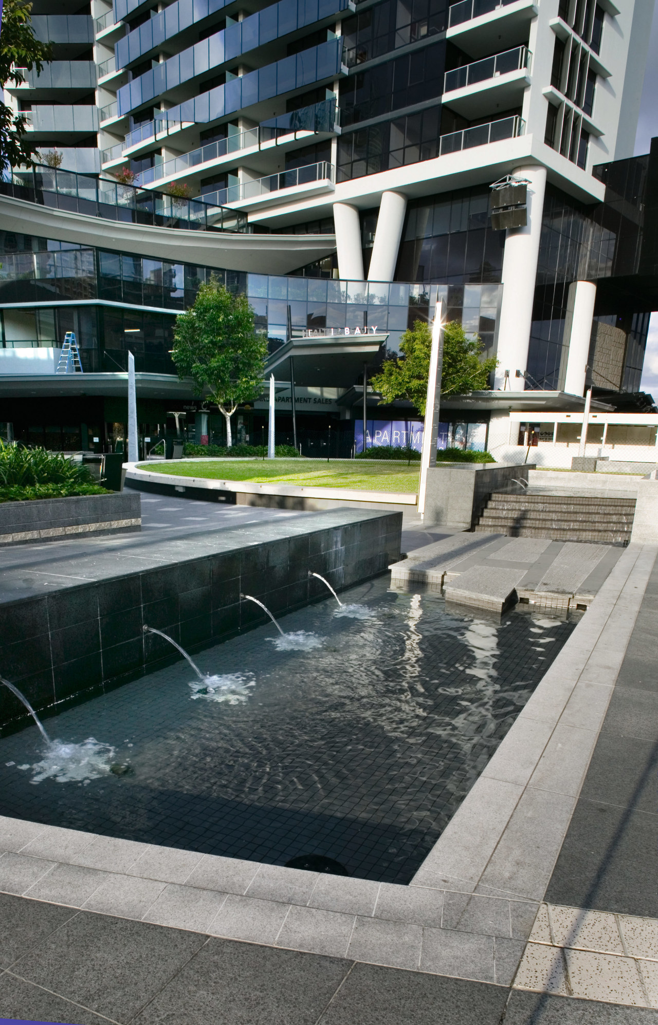 A view of the outdoor water feature at architecture, building, condominium, reflecting pool, reflection, residential area, swimming pool, urban design, water, water feature, gray, black