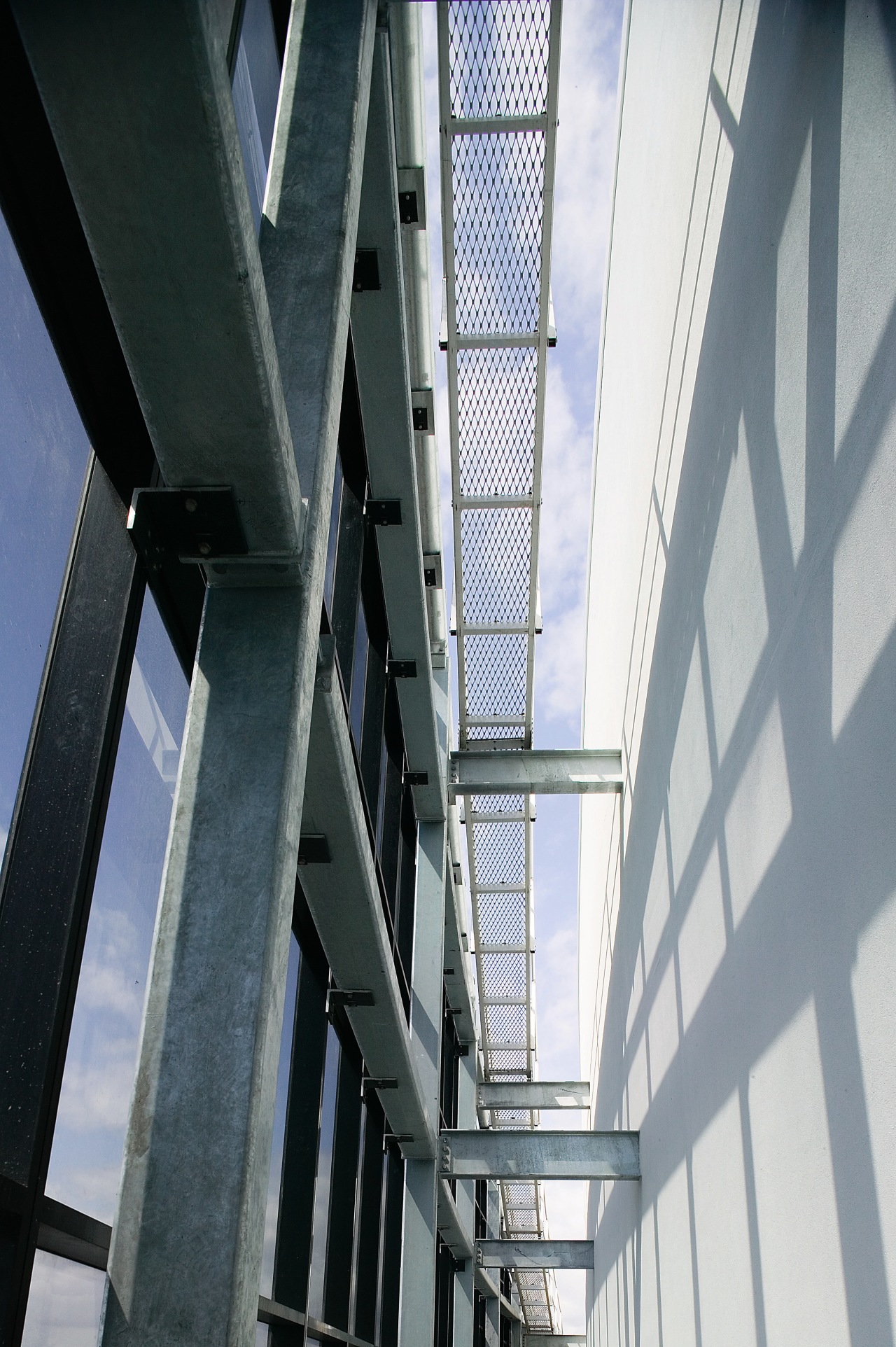 A view of the structural steel manufactured and architecture, building, daylighting, daytime, facade, glass, line, steel, structure, window, gray, black, white