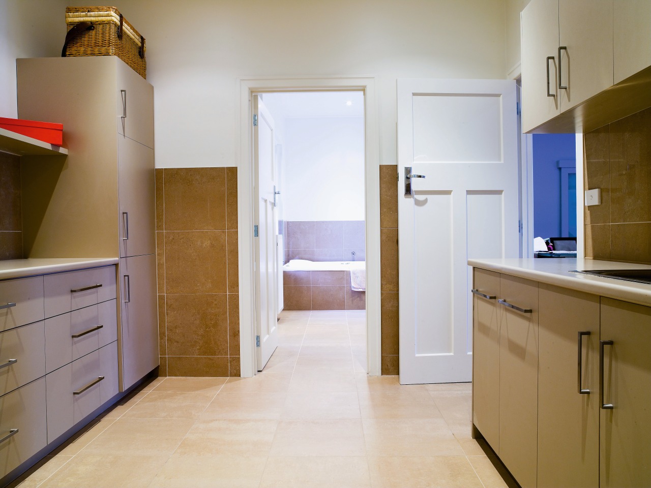 View of a large laundry which features cabinetry, cabinetry, countertop, floor, flooring, hardwood, home, home appliance, interior design, kitchen, real estate, room, wood, wood flooring, gray, brown