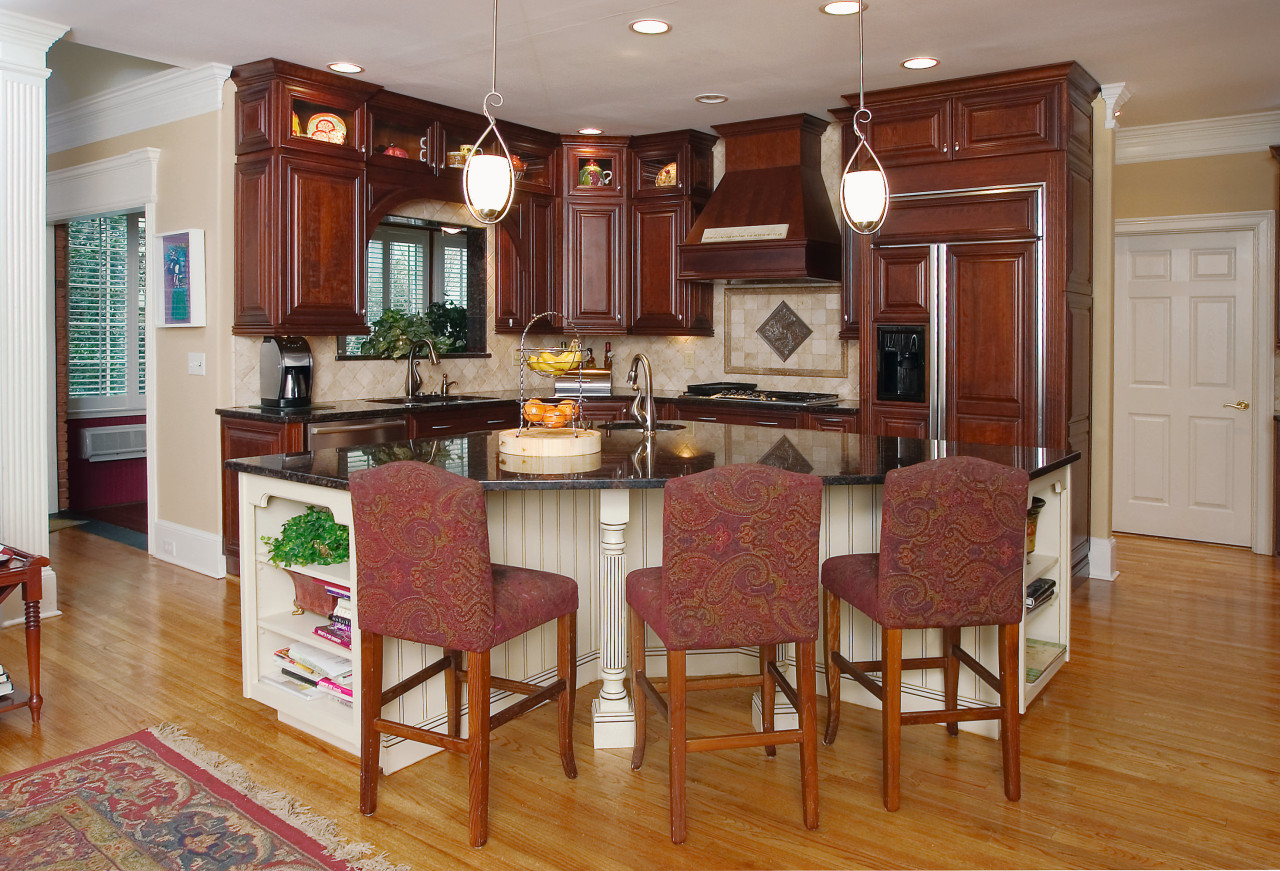 A view of this kitchen featuring custom cherry cabinetry, countertop, cuisine classique, dining room, floor, flooring, hardwood, home, interior design, kitchen, laminate flooring, real estate, room, wood flooring, brown, gray