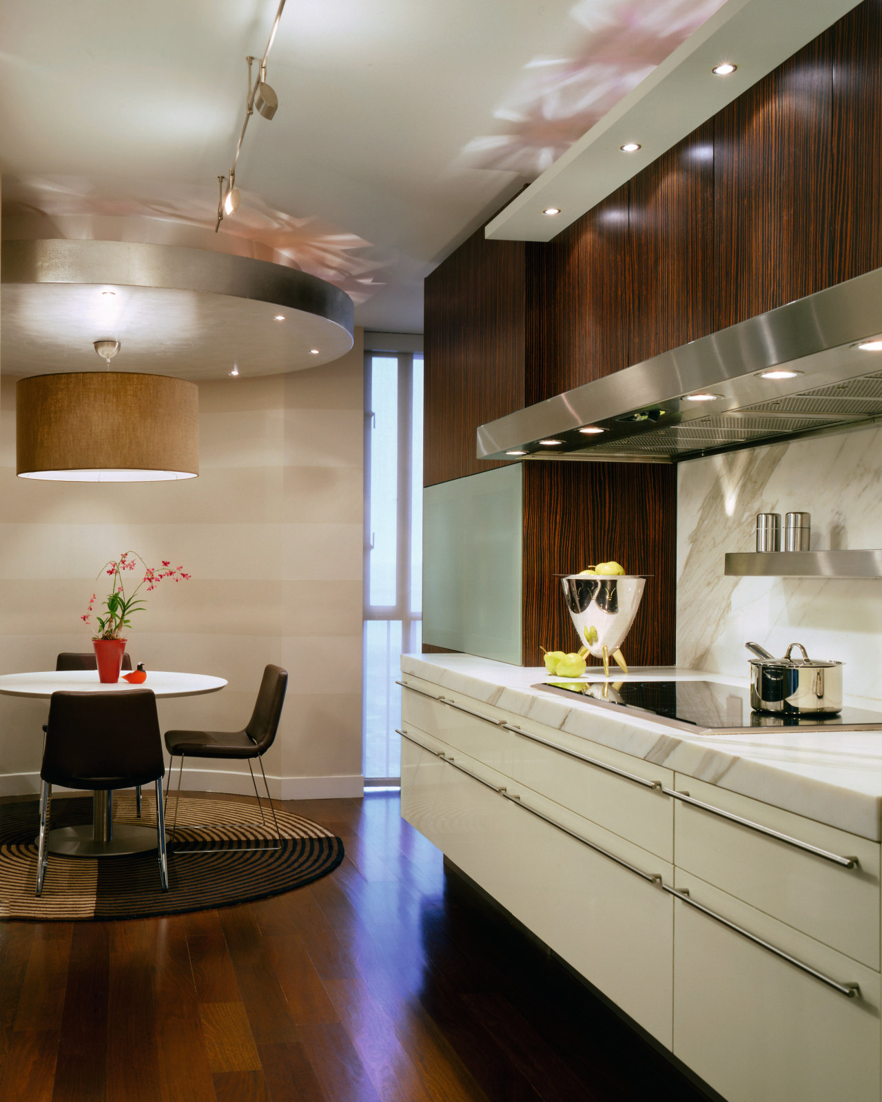 A view of this contemporary lacquered cabinetry from cabinetry, ceiling, countertop, floor, flooring, interior design, kitchen, living room, room, gray, brown