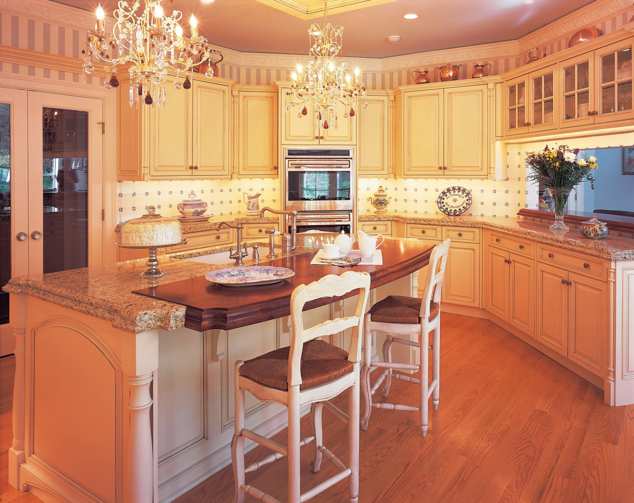 A view of this kitchen featuring traditional colonial cabinetry, countertop, cuisine classique, dining room, floor, flooring, hardwood, home, interior design, kitchen, room, wall, wood, wood flooring, orange