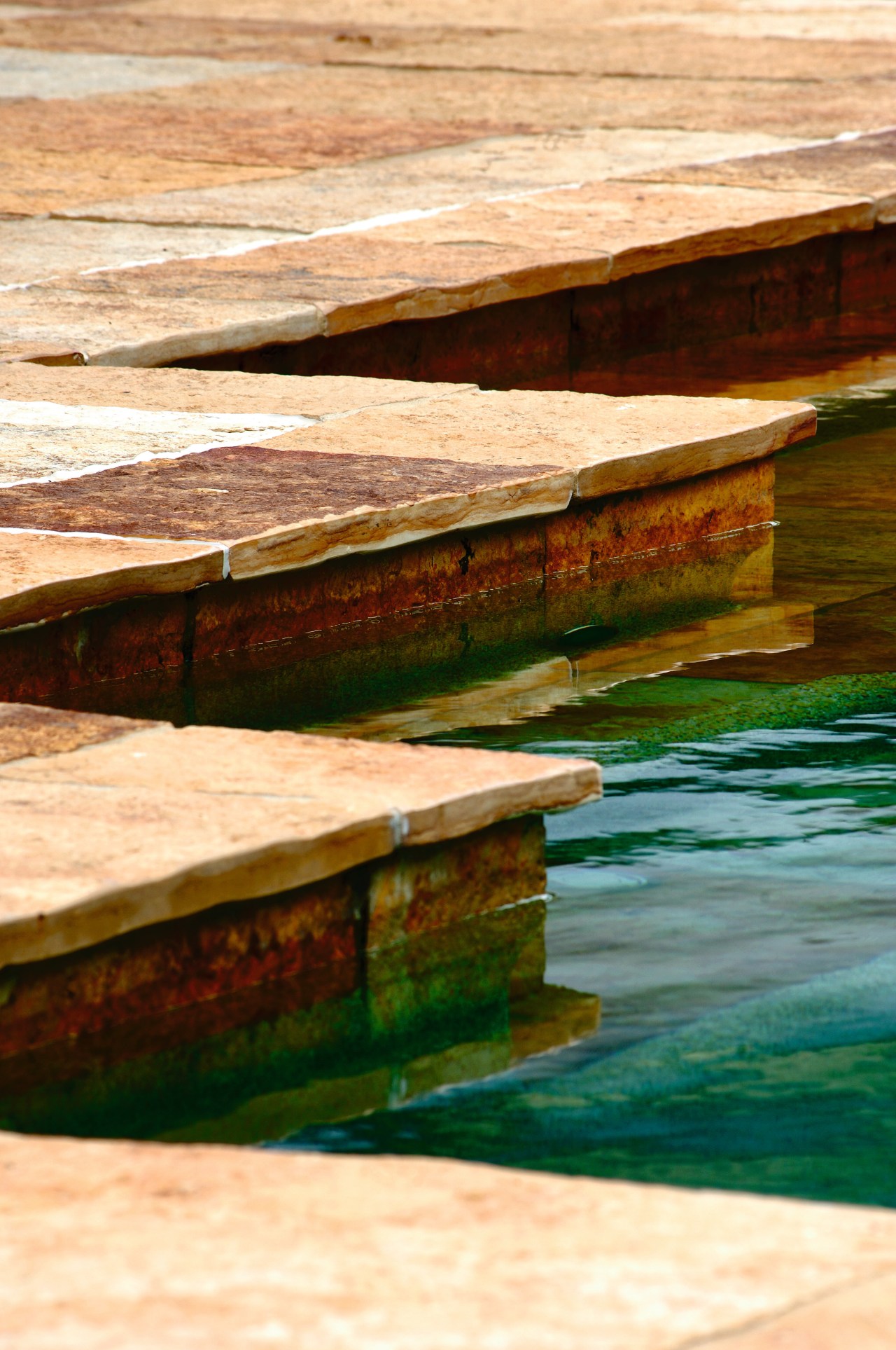 A view of some stone pavers treated with lumber, reflection, table, water, wood, wood stain, orange