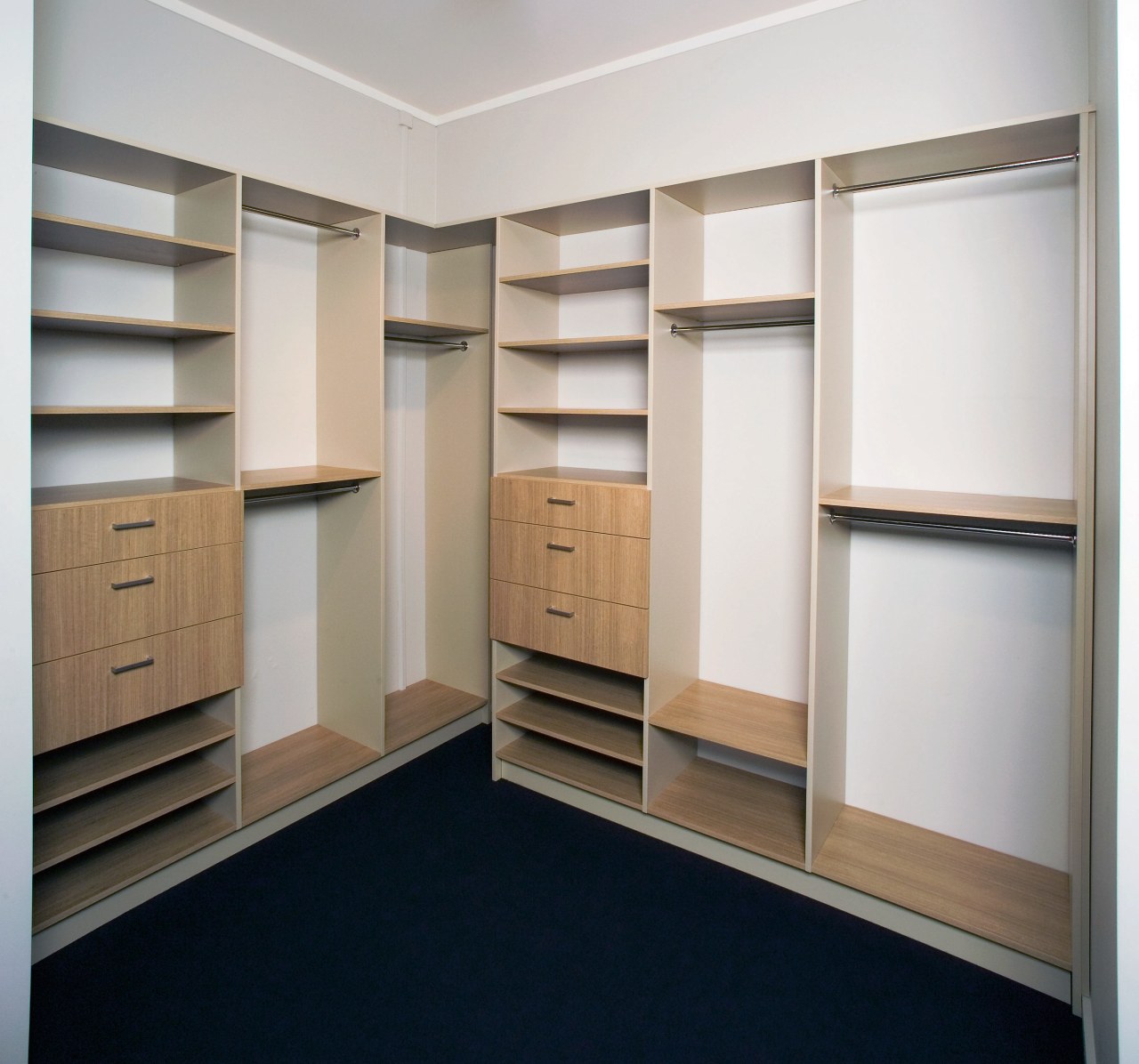 A view of a wordrobe by Innovative Interiors. cabinetry, closet, cupboard, furniture, room, shelving, wardrobe, white